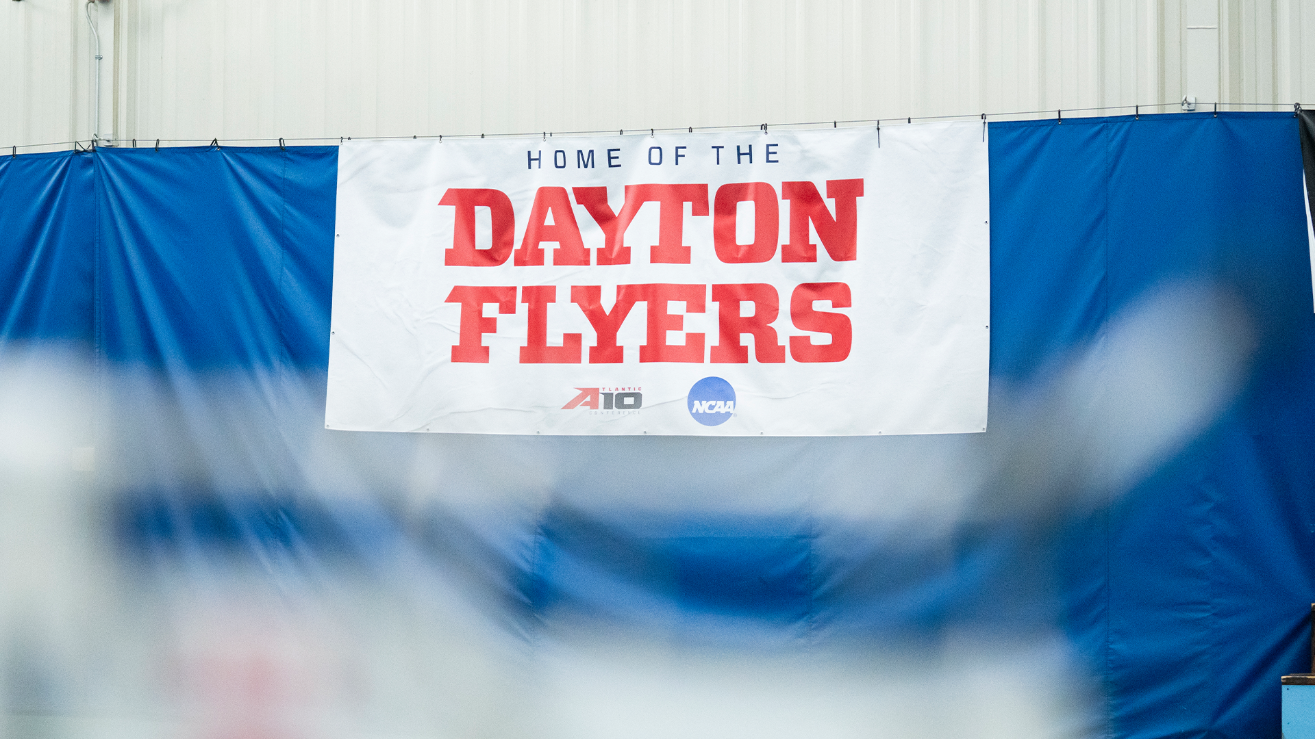 A white banner with red letter says 