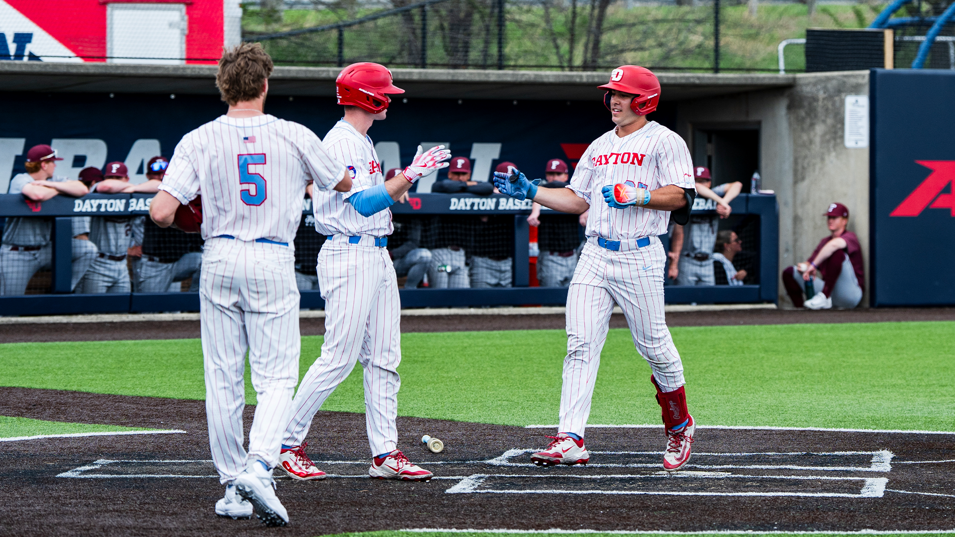 Grayson Carpenter celebrates with Danny MacDougall as he scores a run.