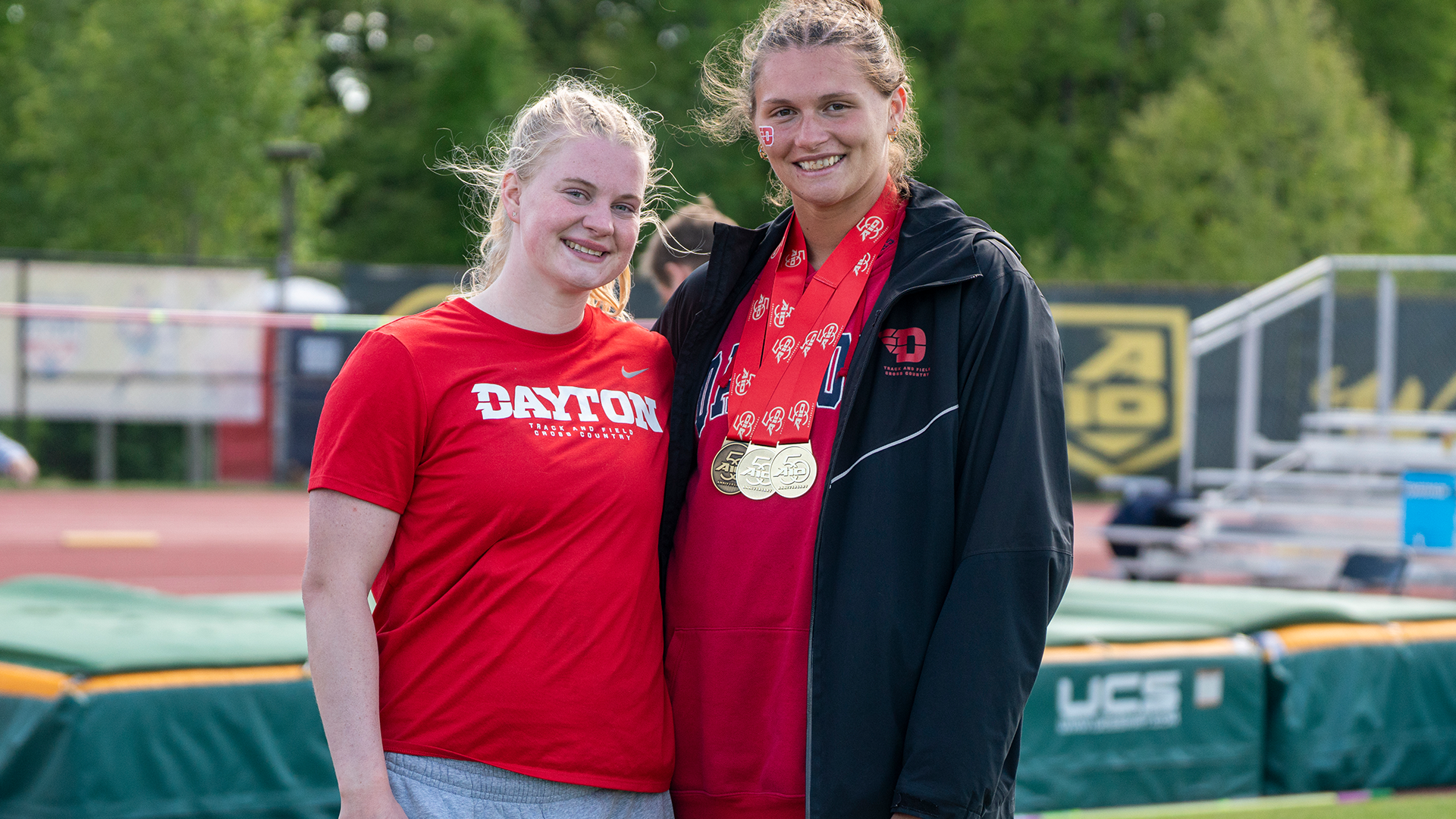 Maggie Hofner (left) and Rebekah Conrad (right) smile for a photo following the Atlantic 10 Outdoor Track and Field Championships