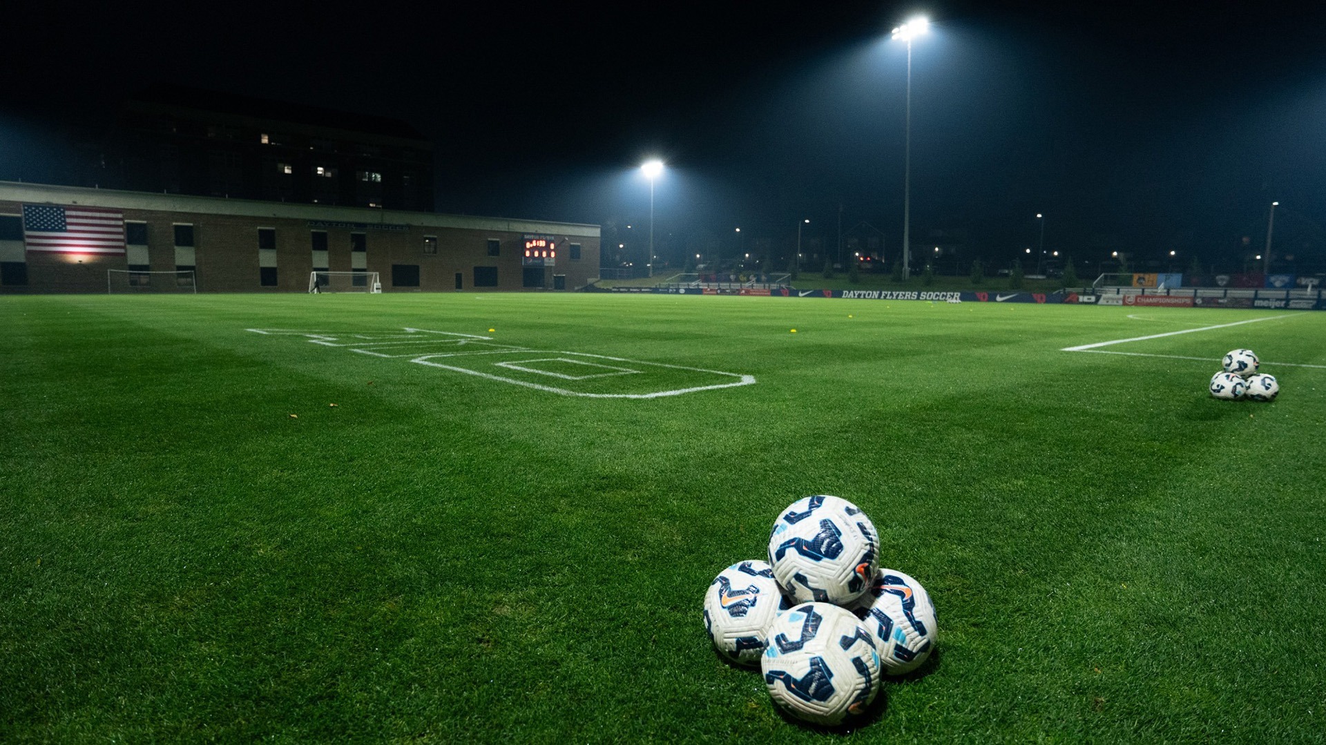 Night photo of Baujan Field before the Atlantic 10 Tournament