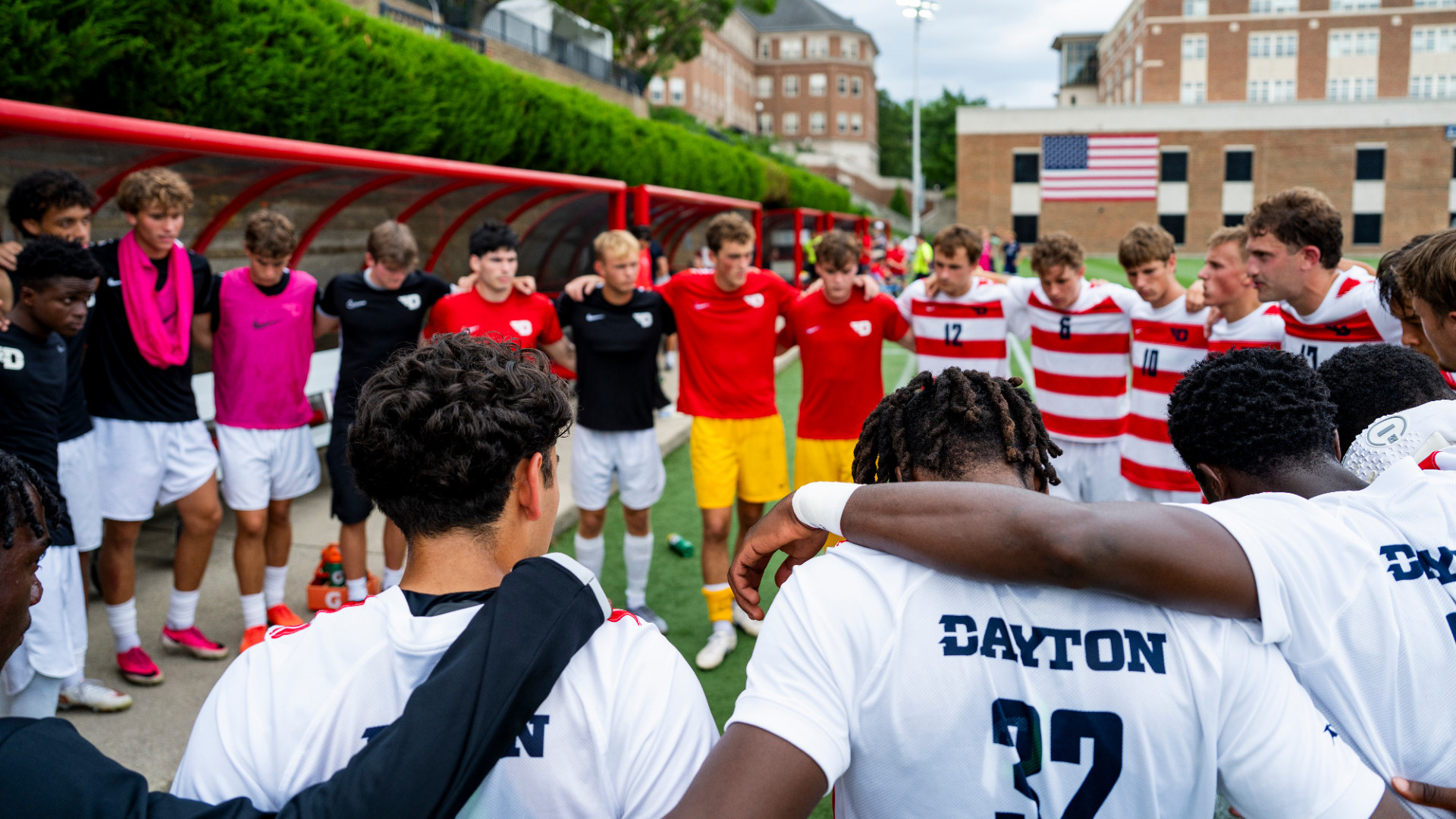 Members of the men's soccer team huddle ahead of a home match against Robert Morris