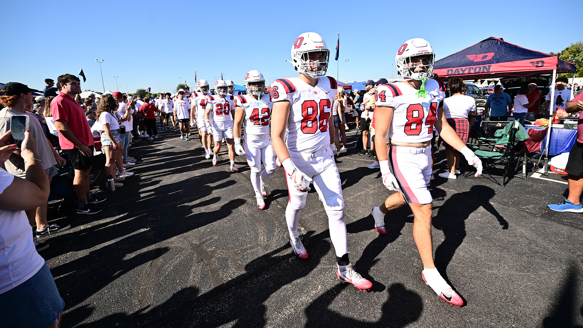Players walking about through the parking lot crowd pregame