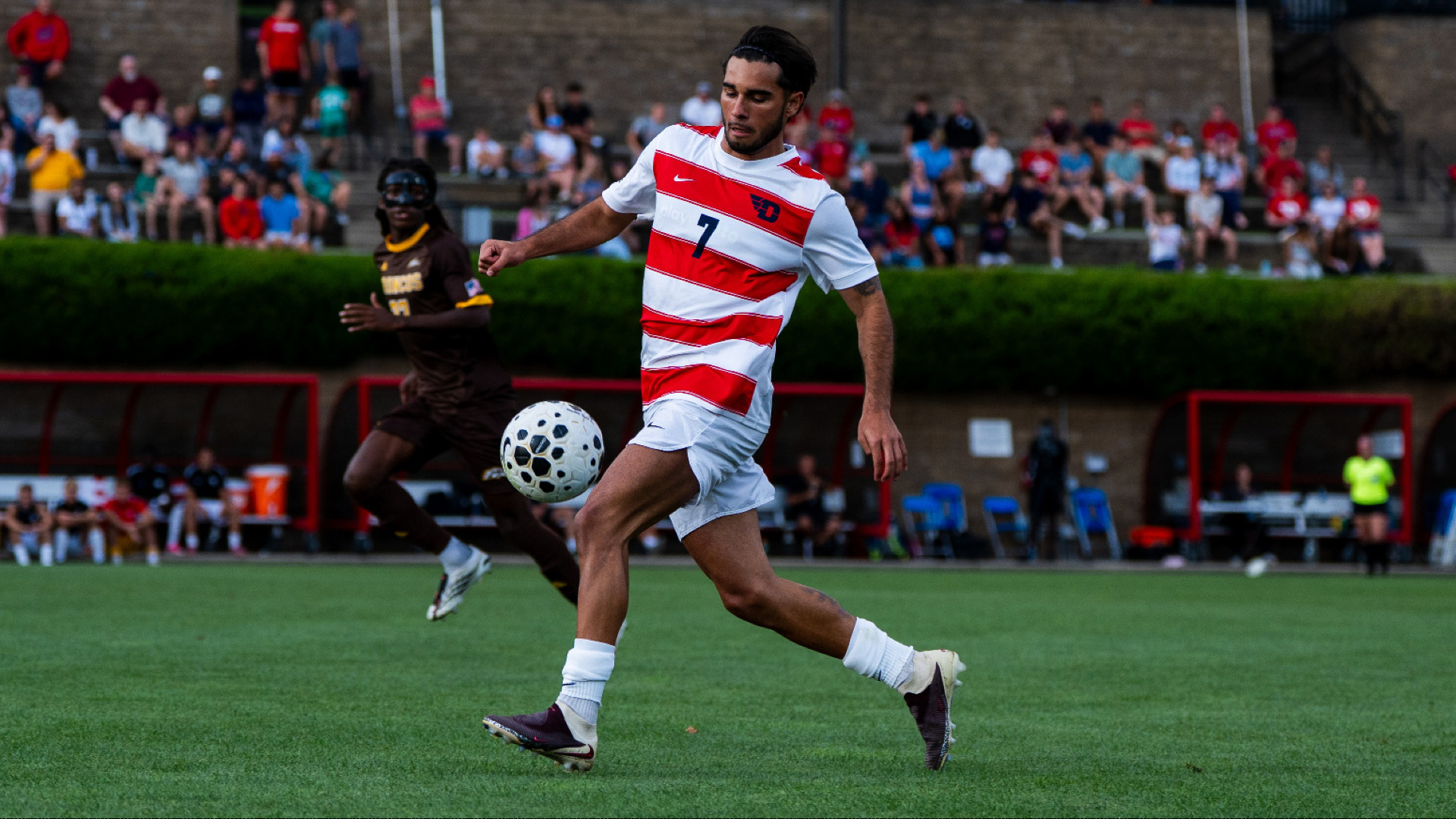 Men's Soccer player Pablo Martinez wearing a red and white jersey with white shorts and white socks