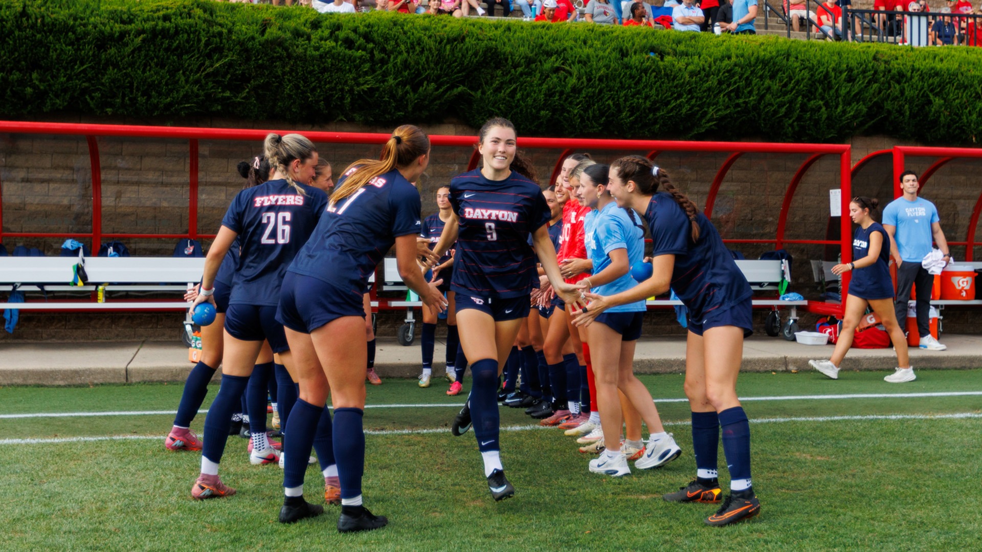 Dayton women's soccer player Reese Gallagher runs out of the starting lineup tunnel prior to a match.