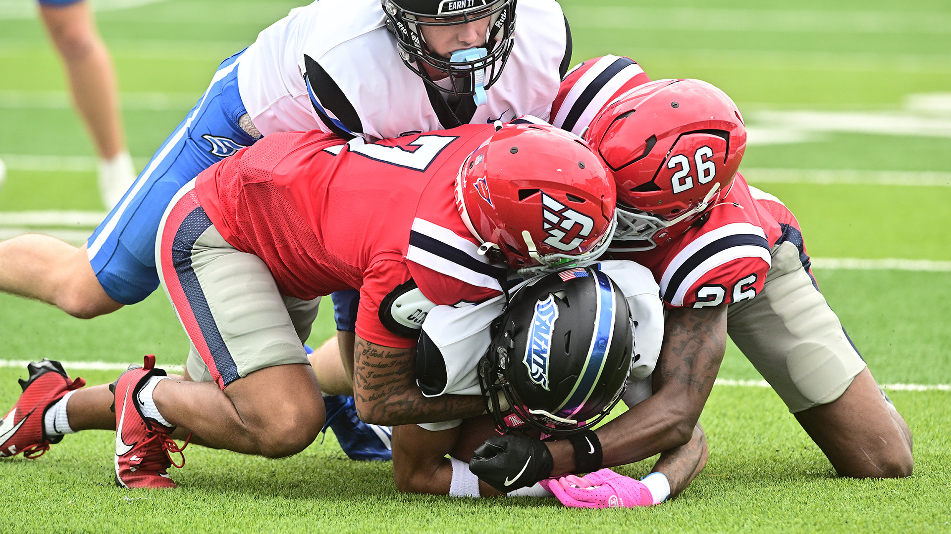 Flyers tackling an opposing ball carrier 
