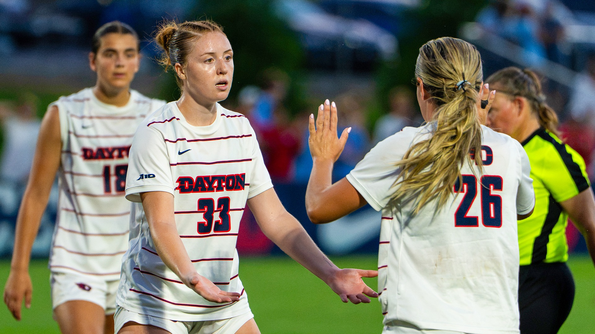Dayton women's soccer players Lauren Fields and Laney Smith give high fives.