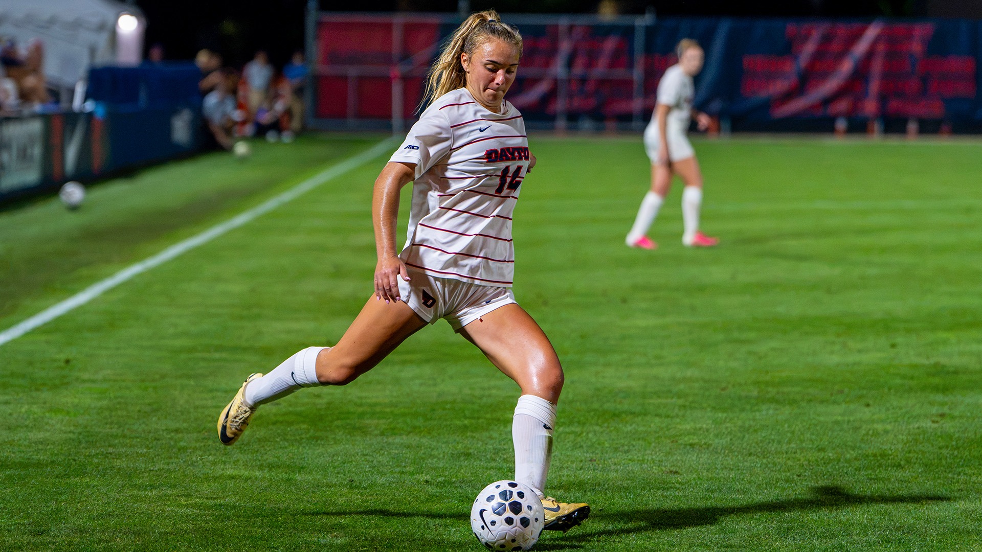 Dayton women's soccer player Eva Schreiber kicks a ball with her right foot in a match at Baujan Field.