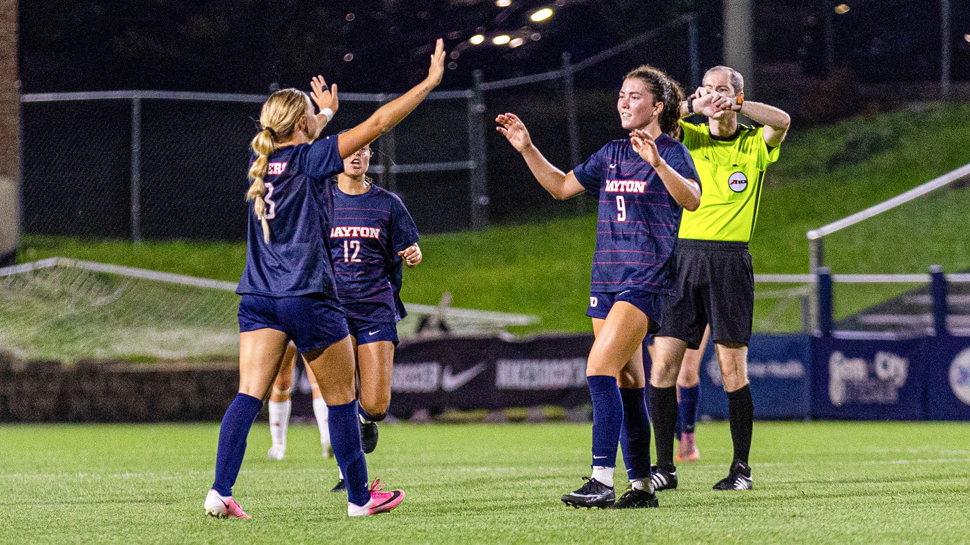 Dayton women's soccer player Reese Gallagher celebrates scoring her first collegiate goal with Emery Newlin.