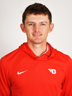 Portrait image of mens' golf head coach Collin Toner wearing a red pullover hooded shirt with a white flying D logo