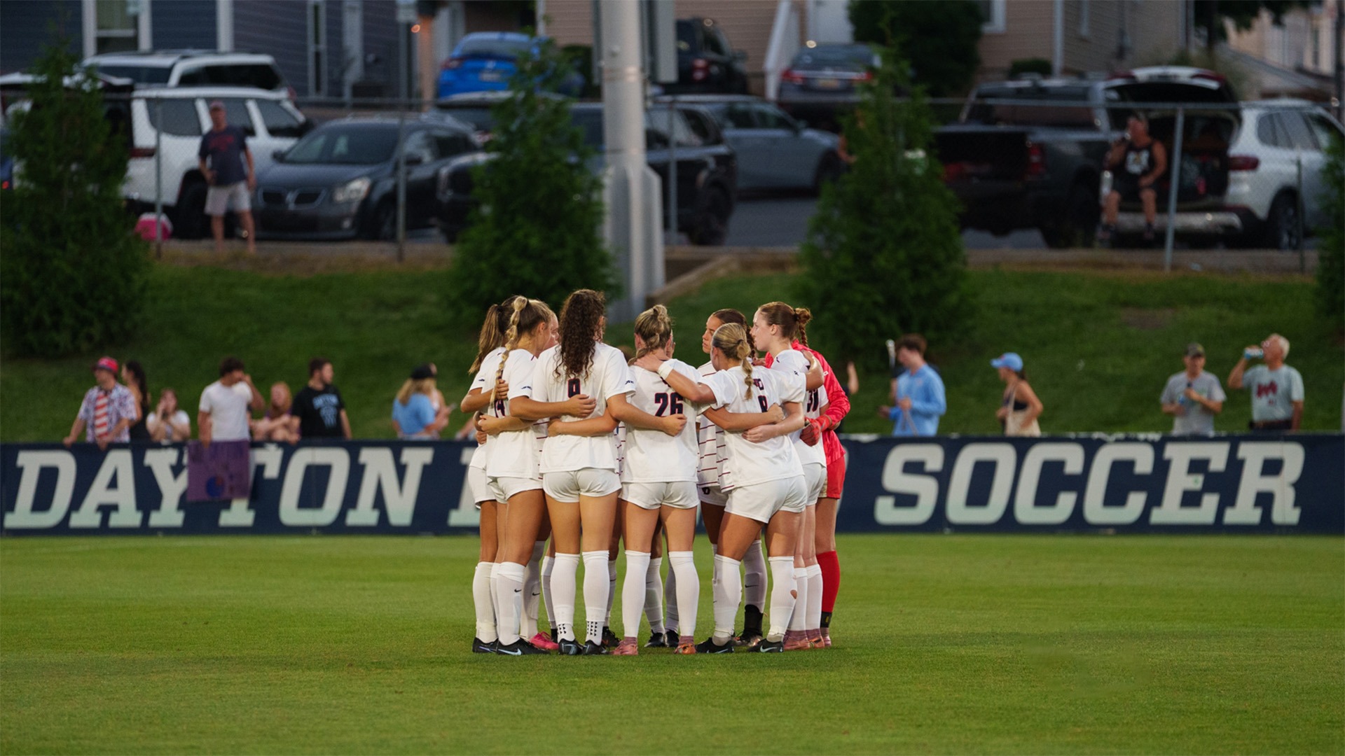 The University of Dayton women's soccer team huddles in a match against Wright State University.
