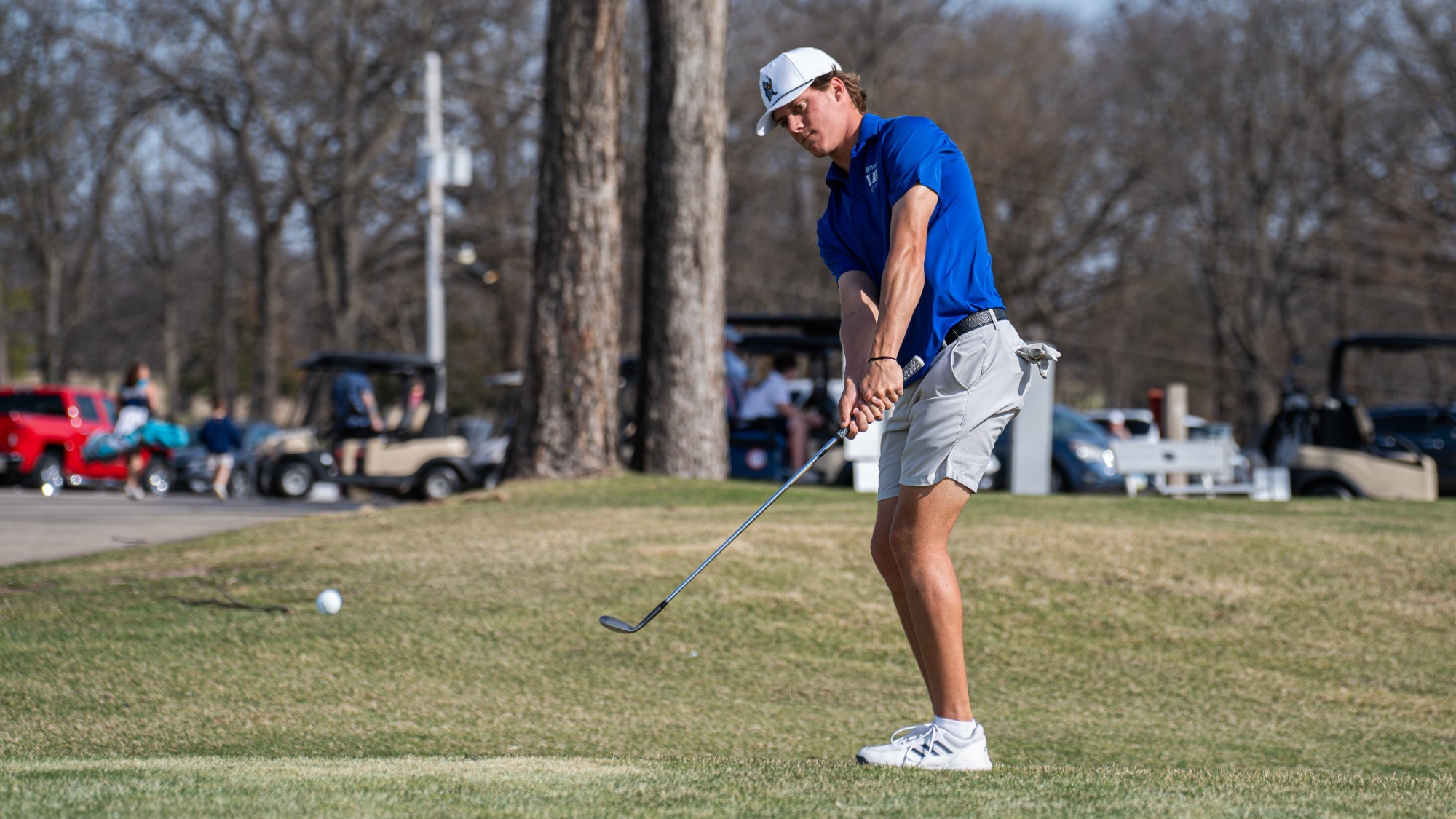 Harwick hitting a golf shot at practice in 2026