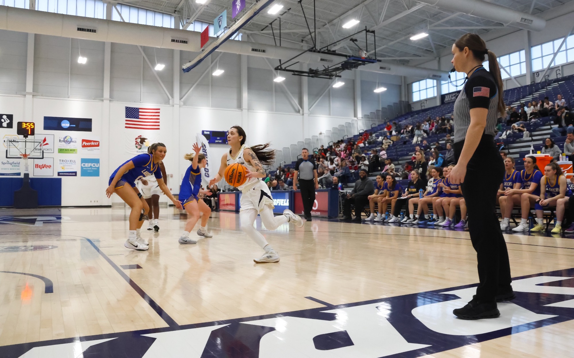 Kennedy Osterman playing basketball in front of home crowd