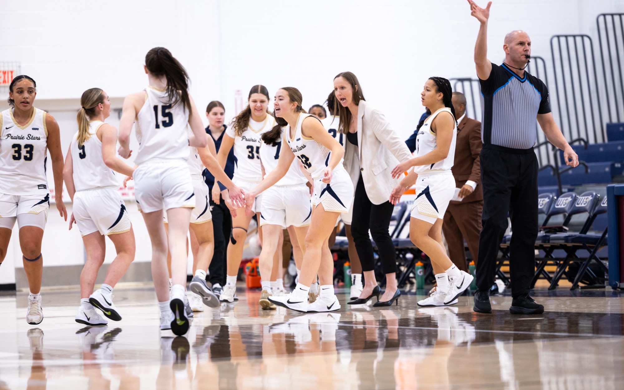 UIS WBB team celebrating on court