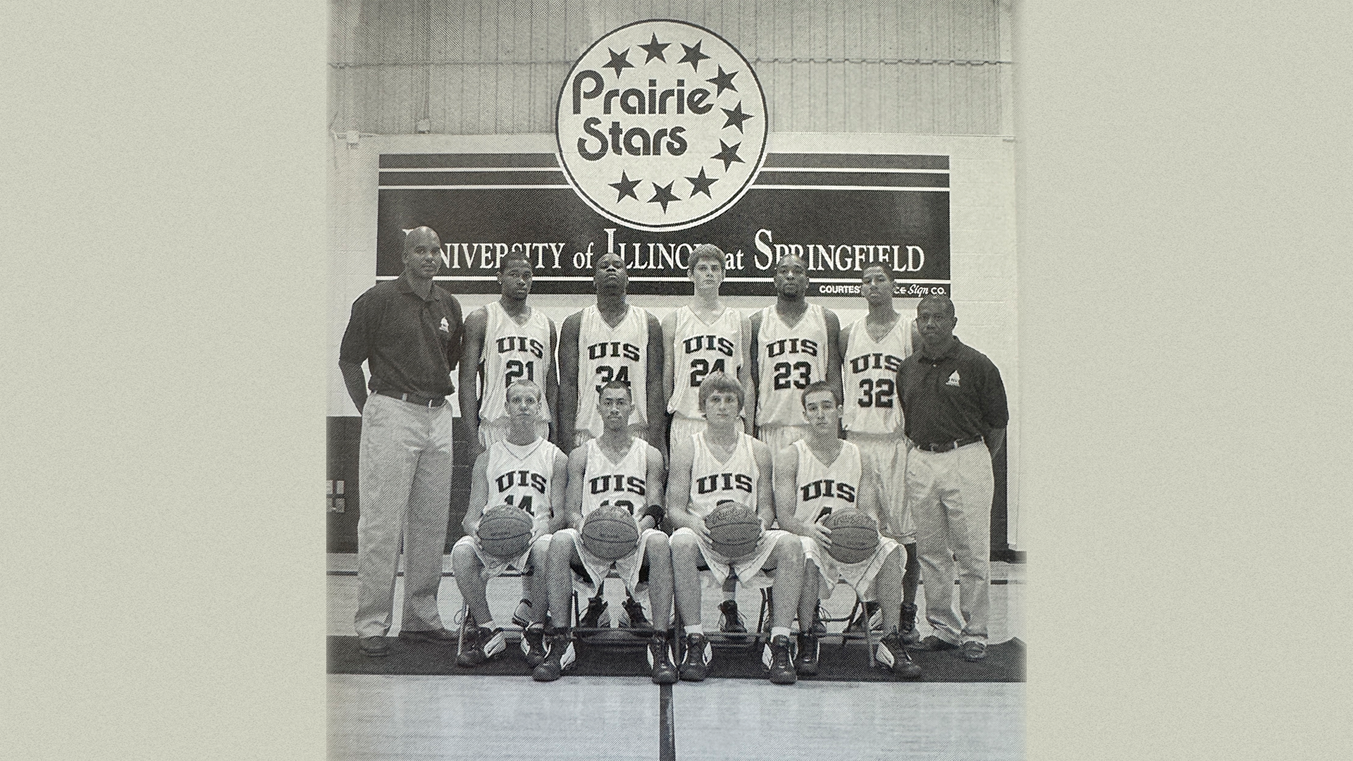 A newspaper clipping of head UIS Basketball Coach Kevin Gamble and his team