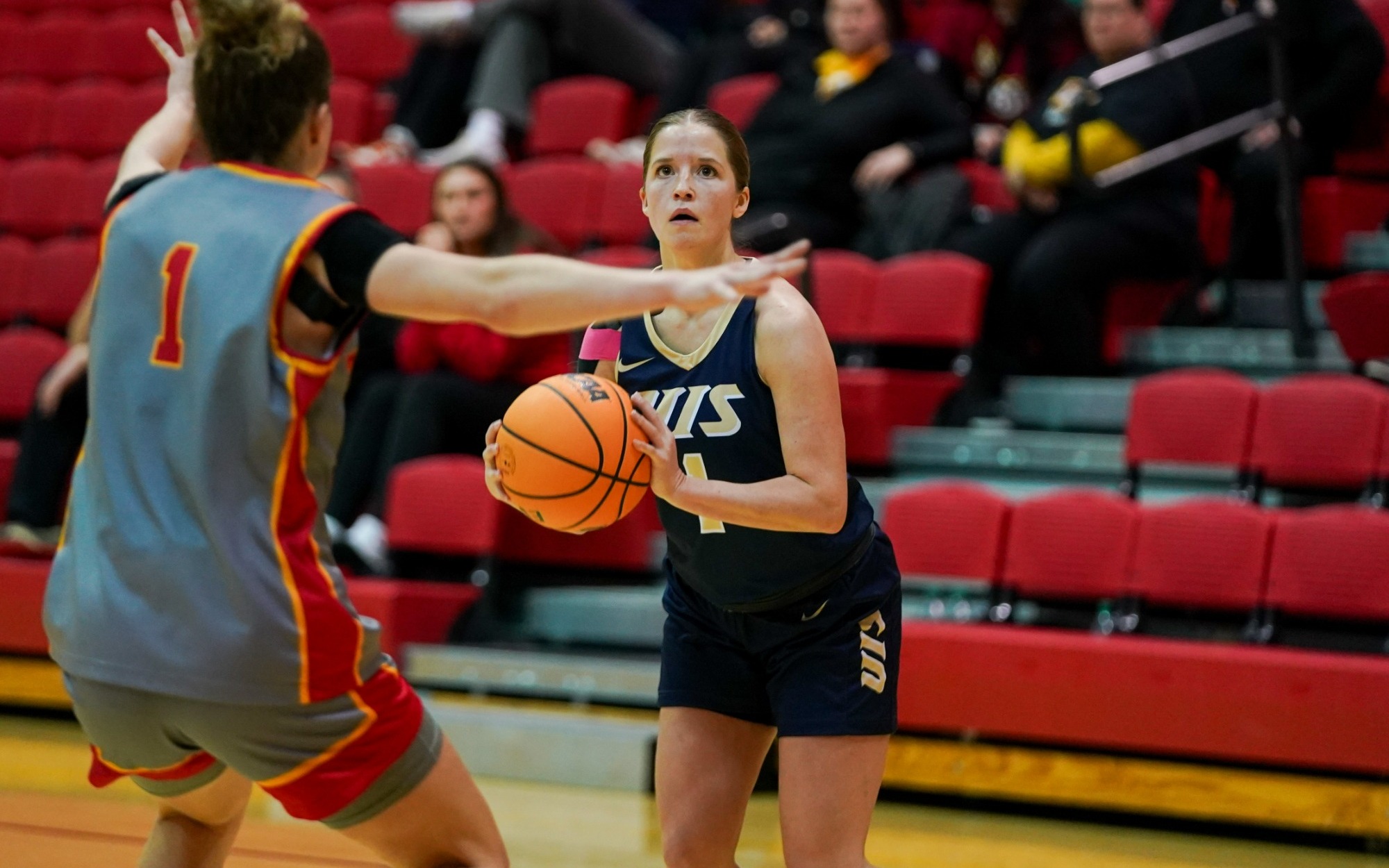 Brynn Tabeling playing basketball in blue UIS uniform