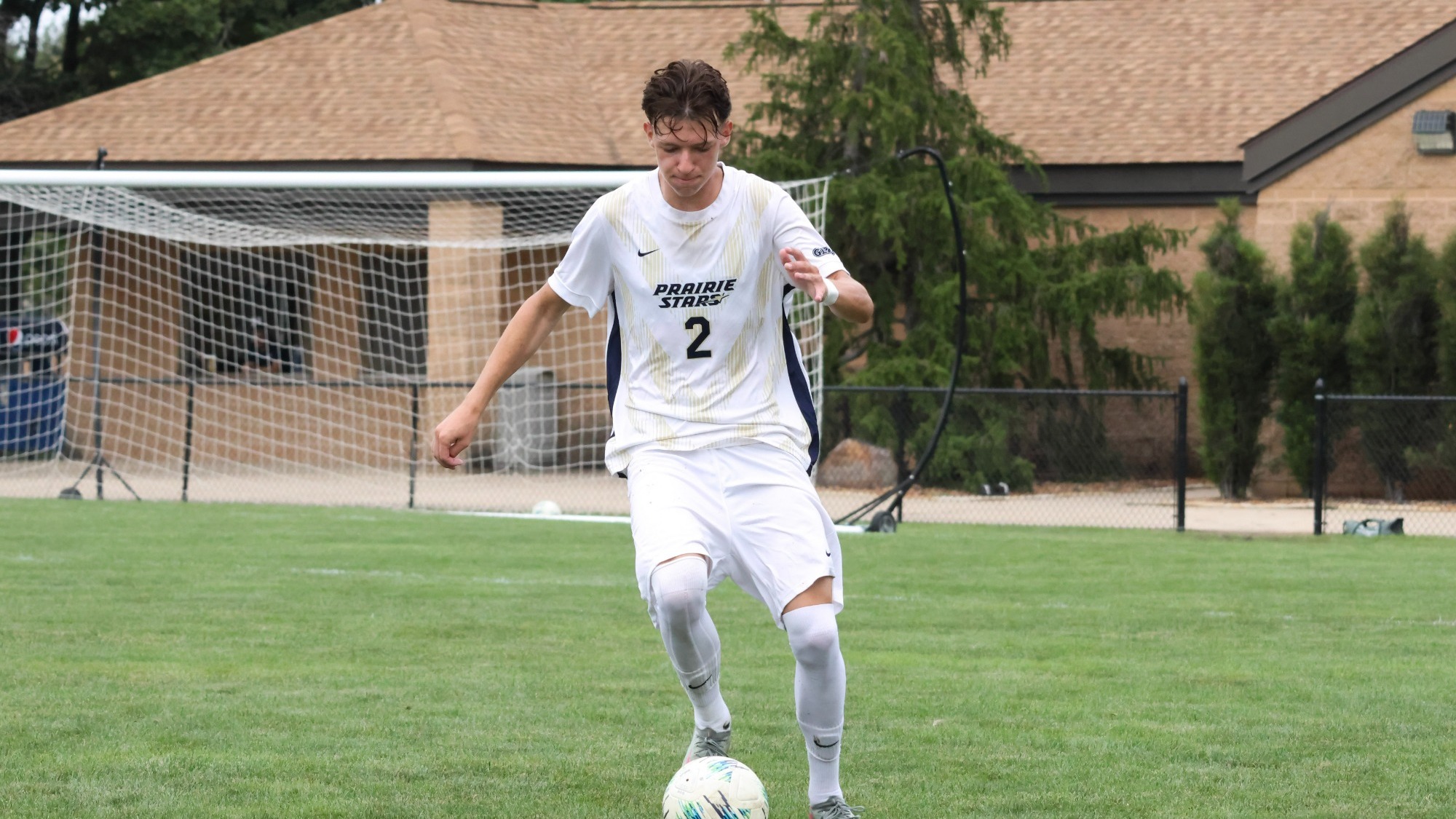 Lennard Borgs playing soccer in white UIS uniform