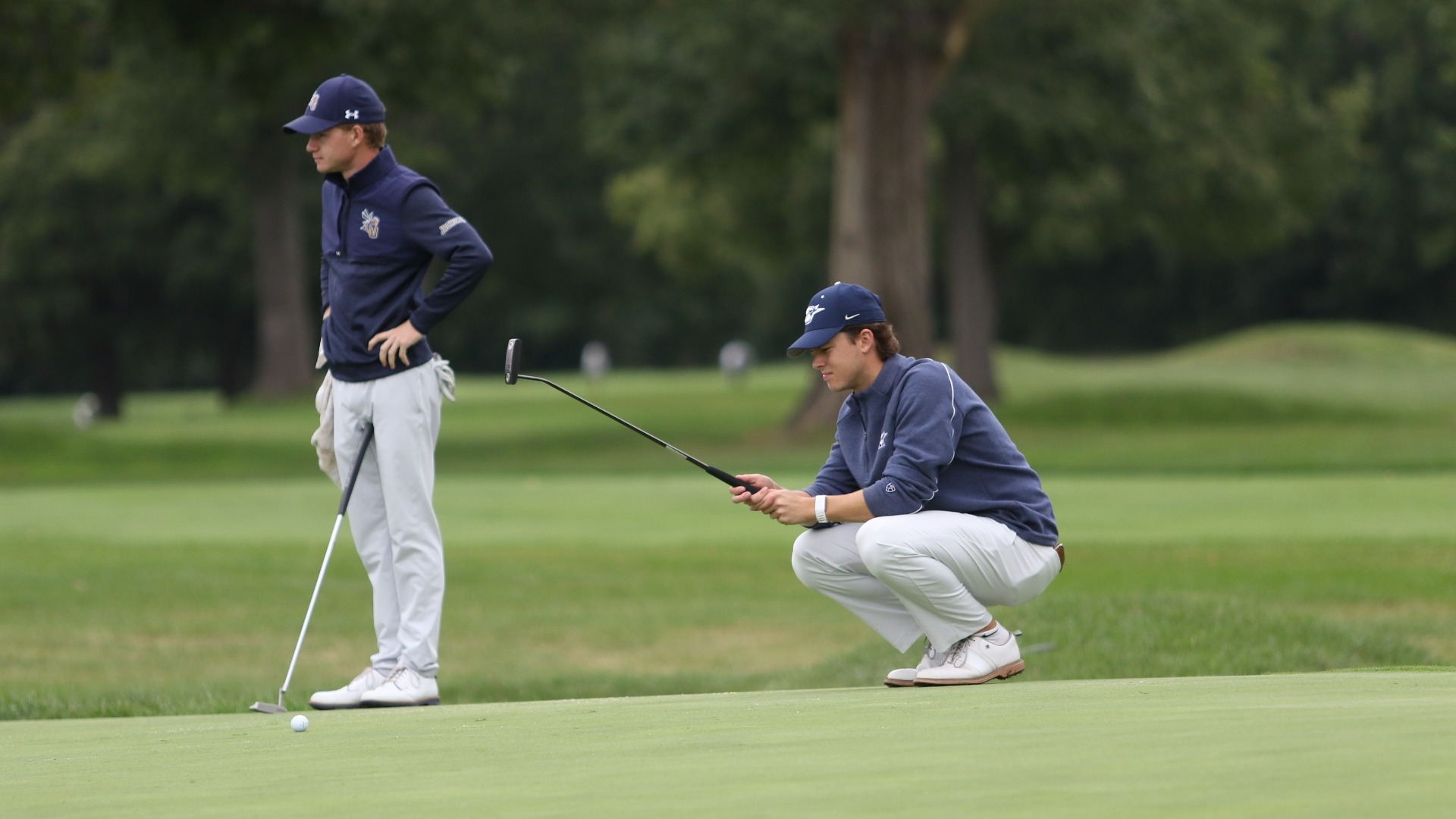 UIS golfer scouting a putt