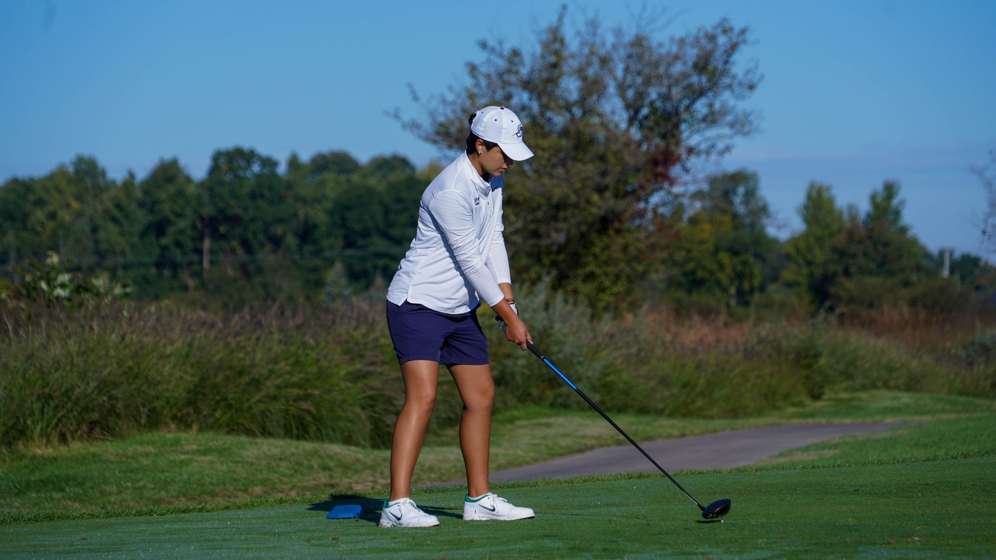 Valentina Torralba golfing in UIS white and blue