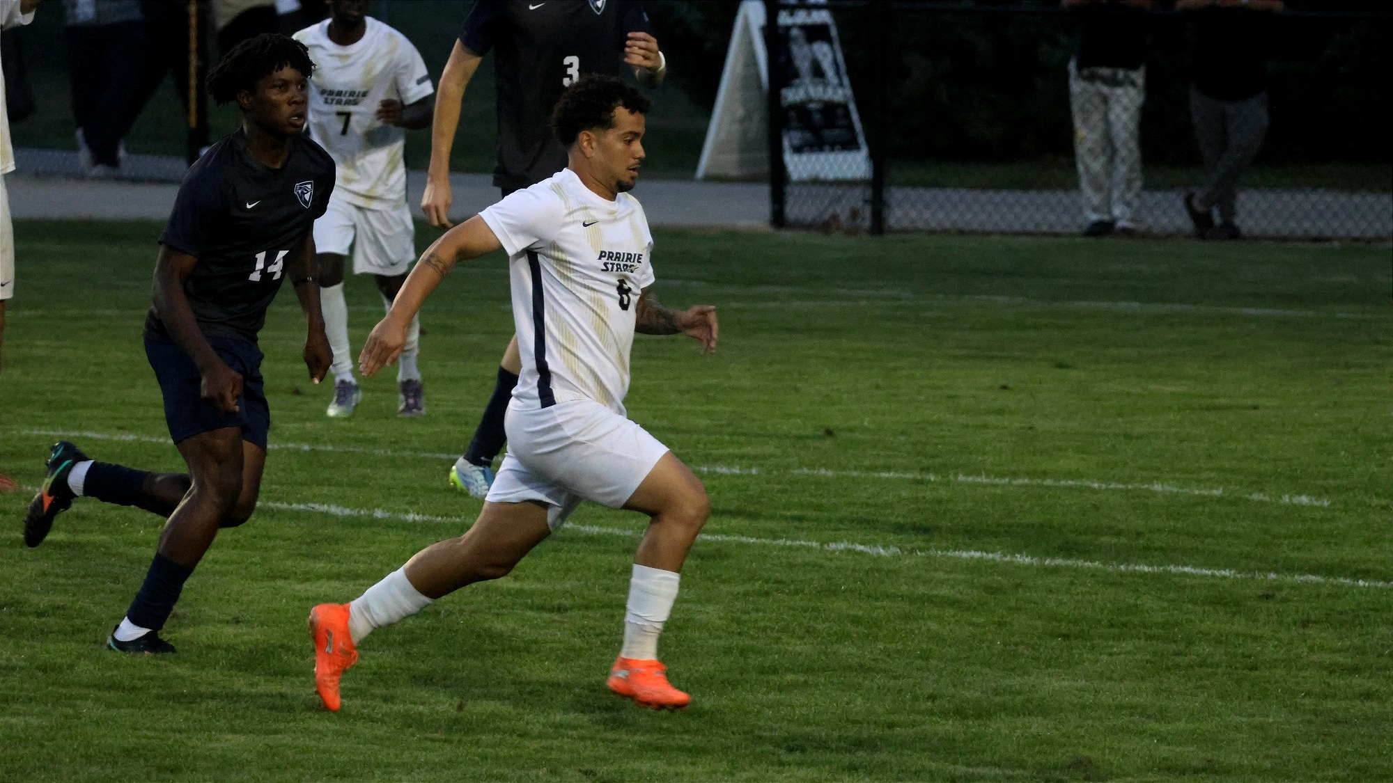 Leo Sanches playing soccer in white UIS uniform