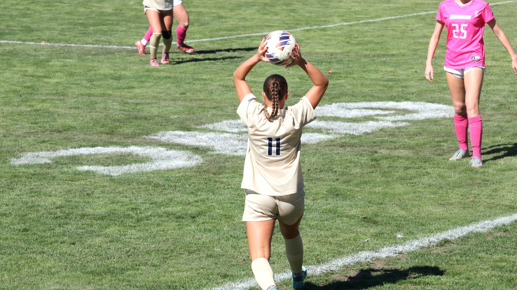 Alaina Stock throw-in in gold UIS uniform