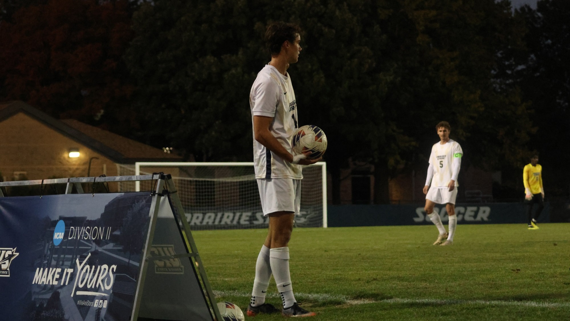 Liam McLean throwing in the soccer ball