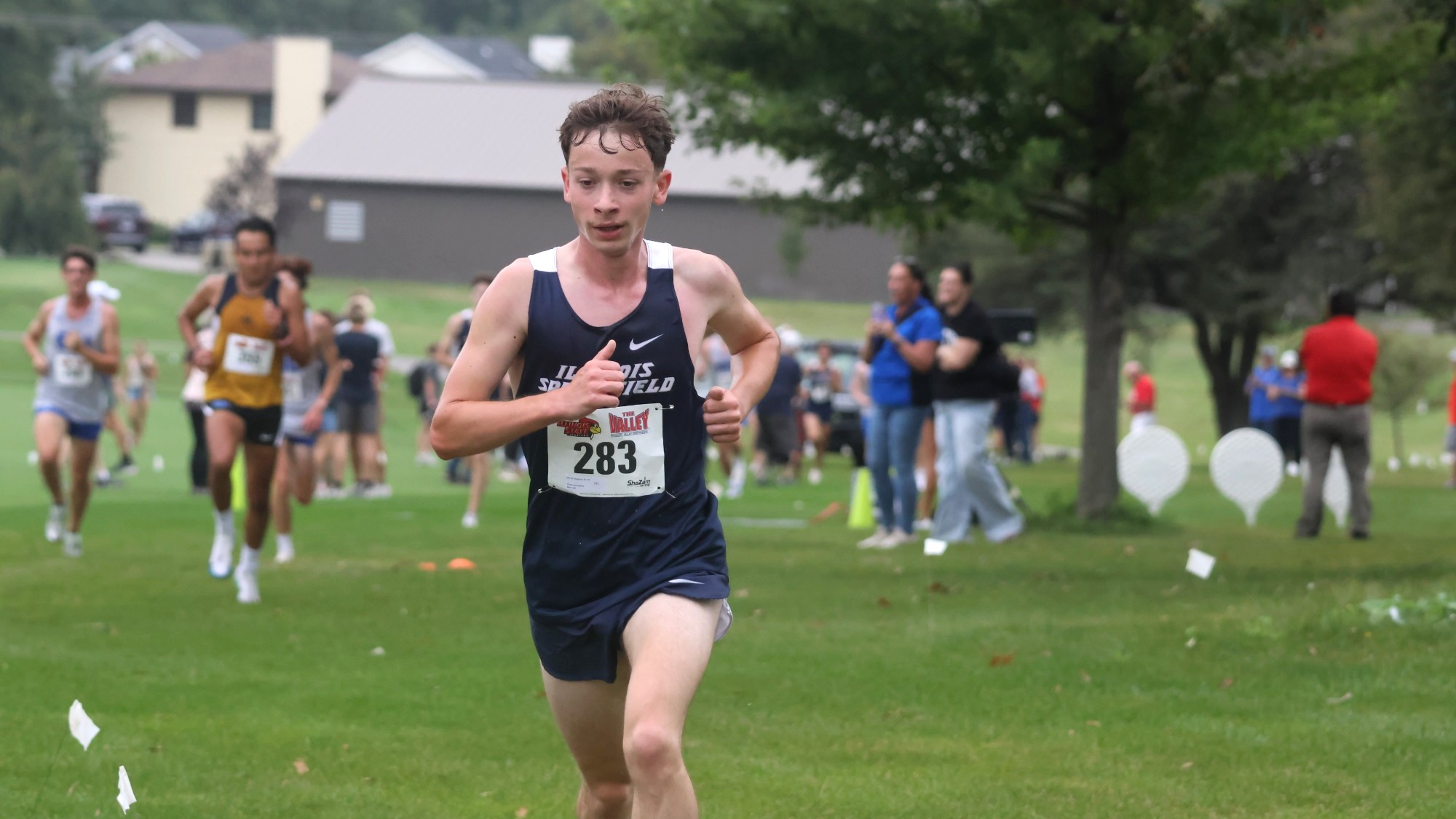 Garrett Wagoner running cross country in blue UIS uniform