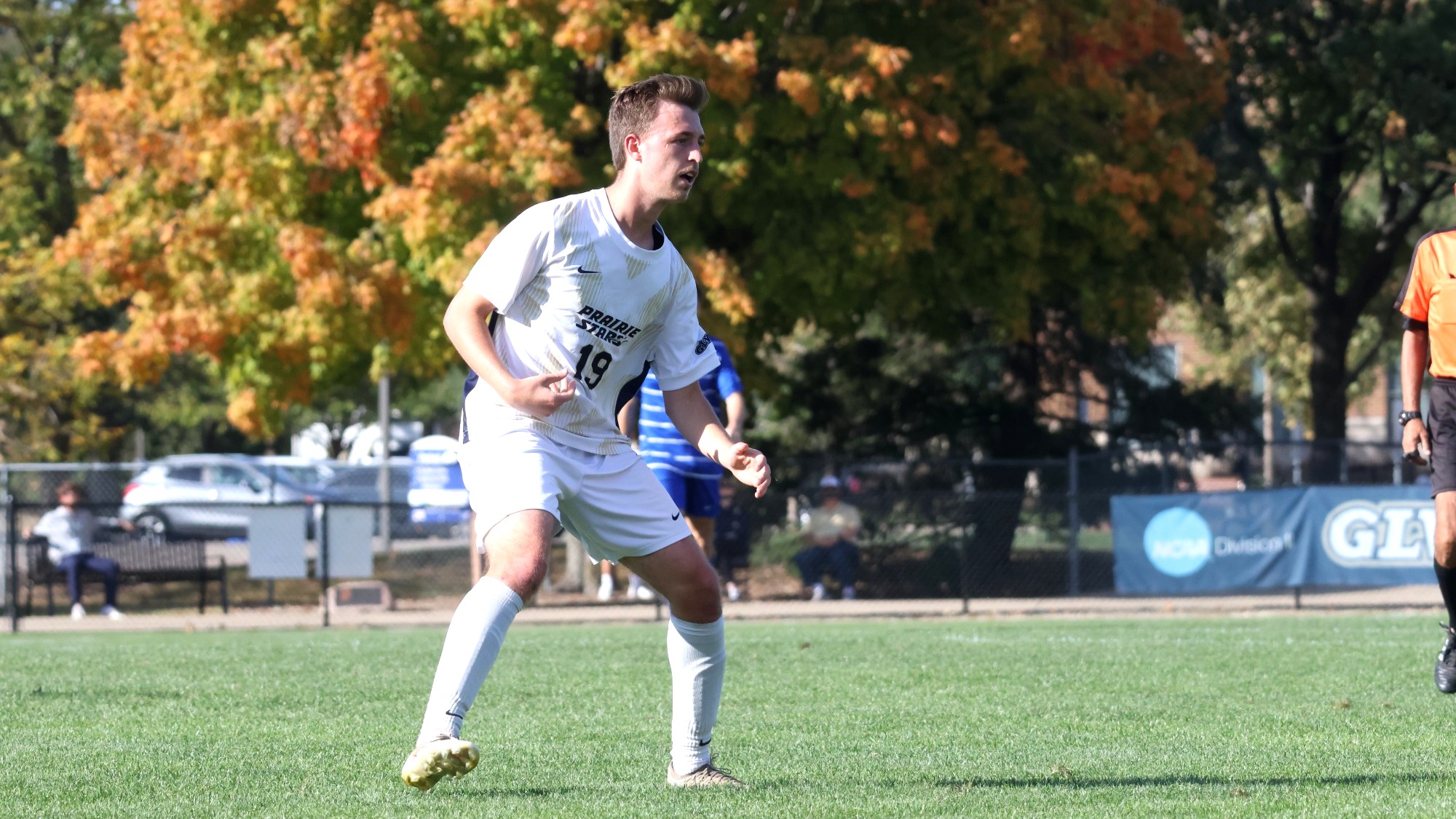 Cam Frye playing soccer in white UIS uniform