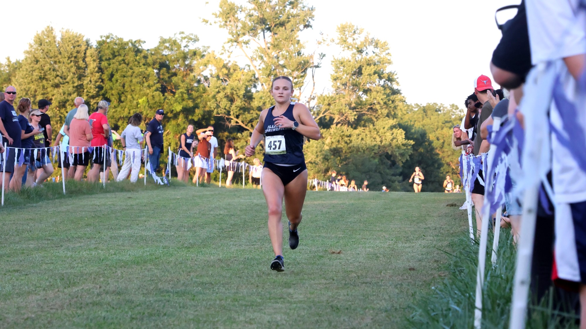 Marissa Roggensack running cross country in UIS blue