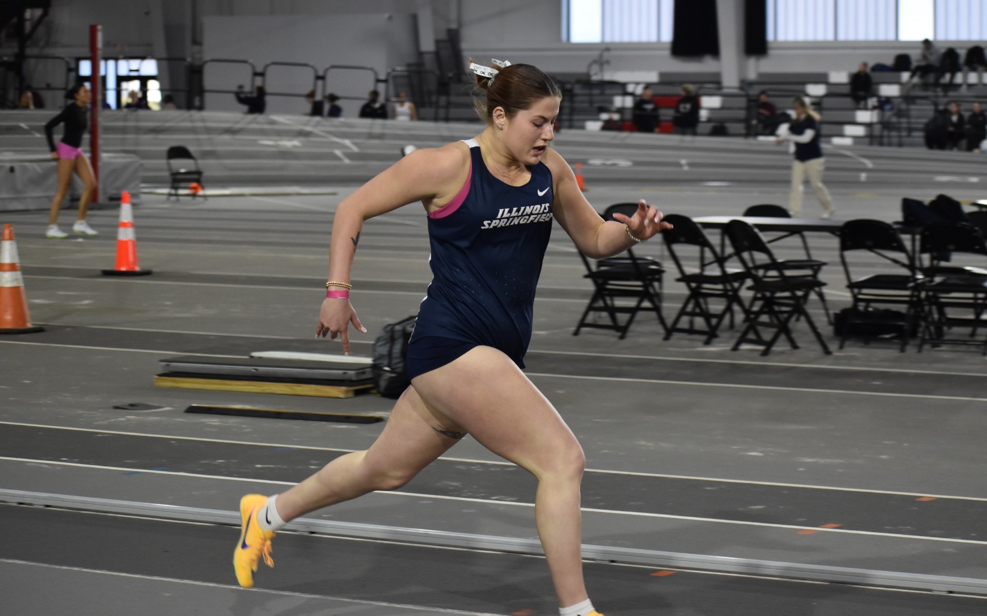 Kalli Drexler running track in blue UIS uniform