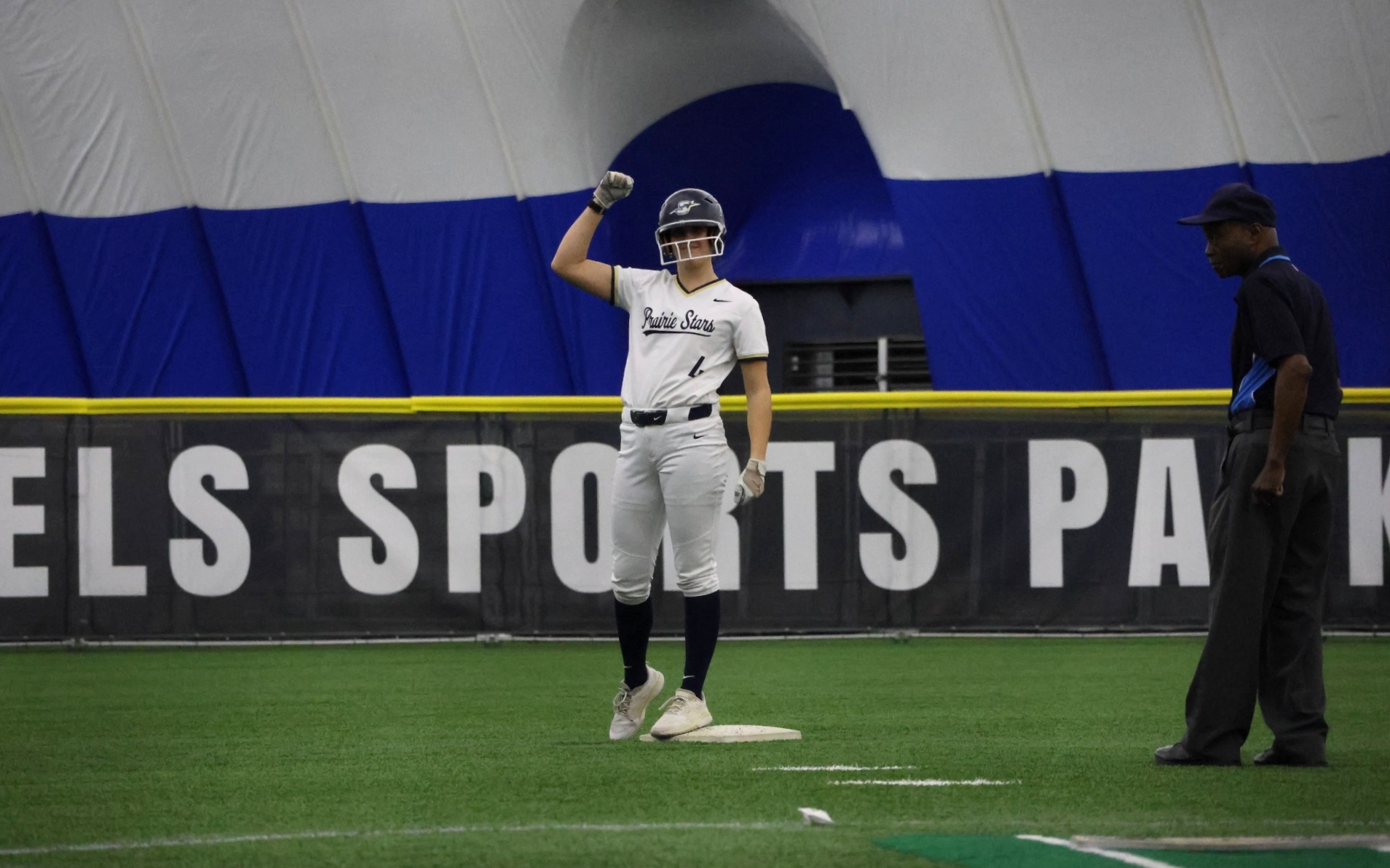 Bailey Masching on second base in white UIS softball uniform