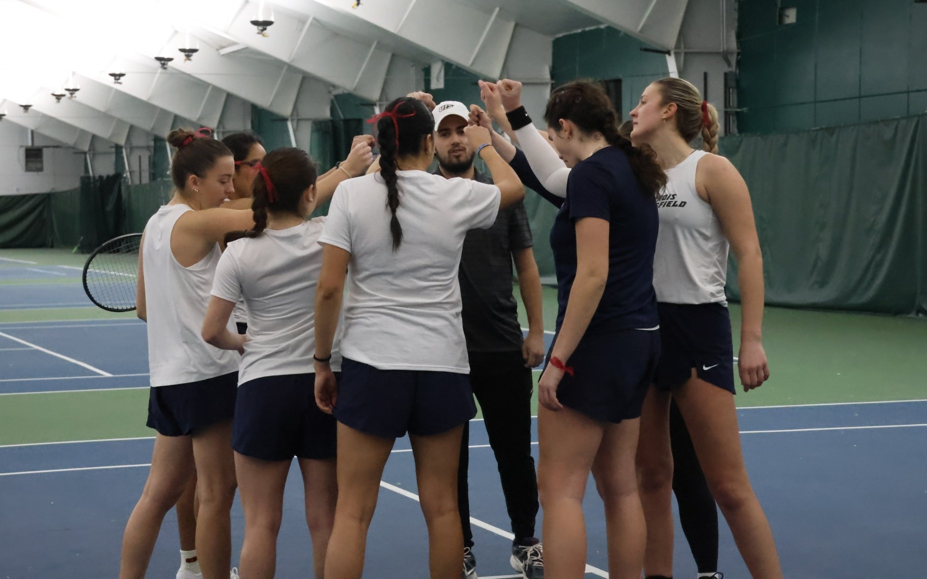 UIS women's tennis team huddle