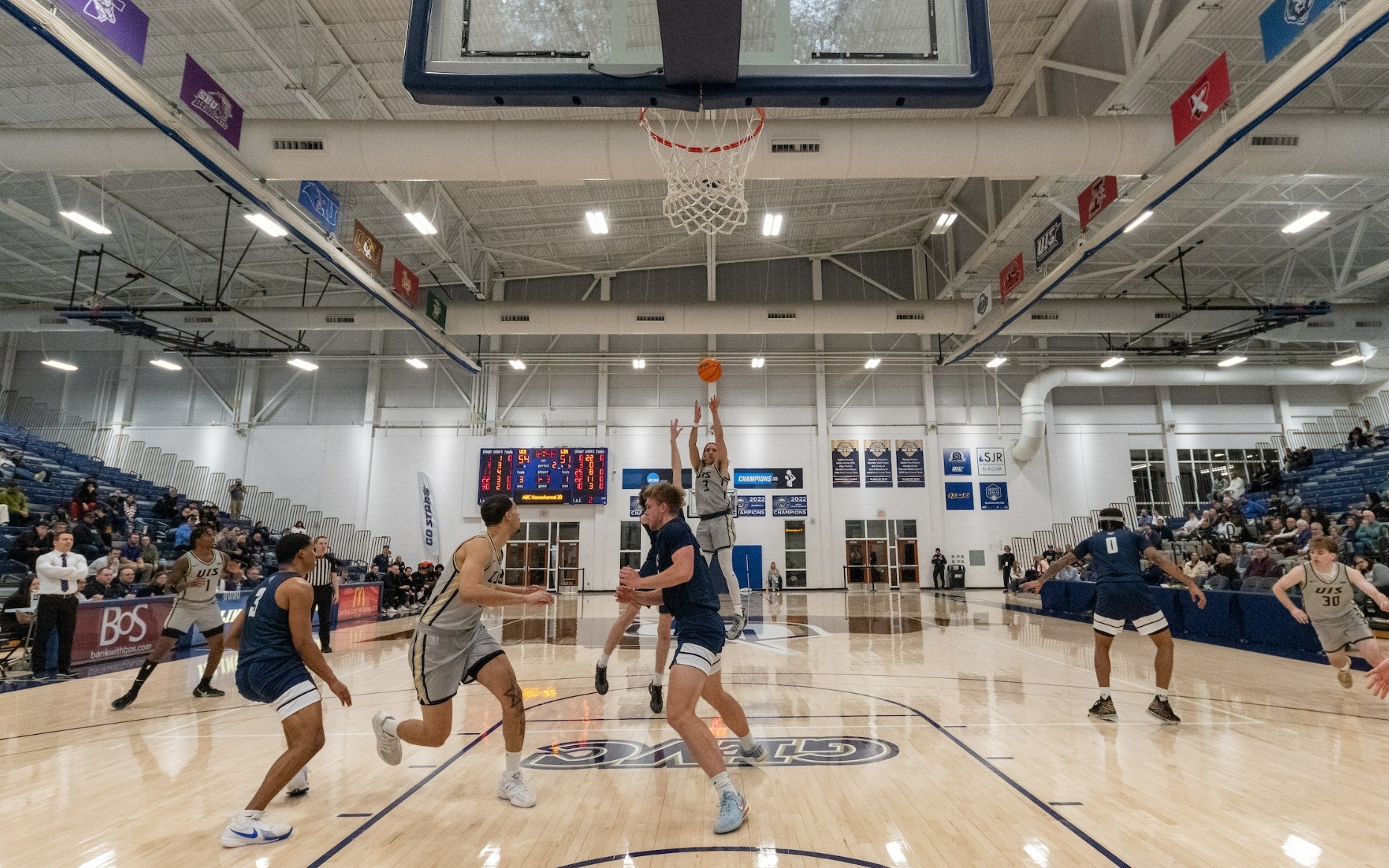 Adidas Davis attempting three-point shot on UIS basketball court