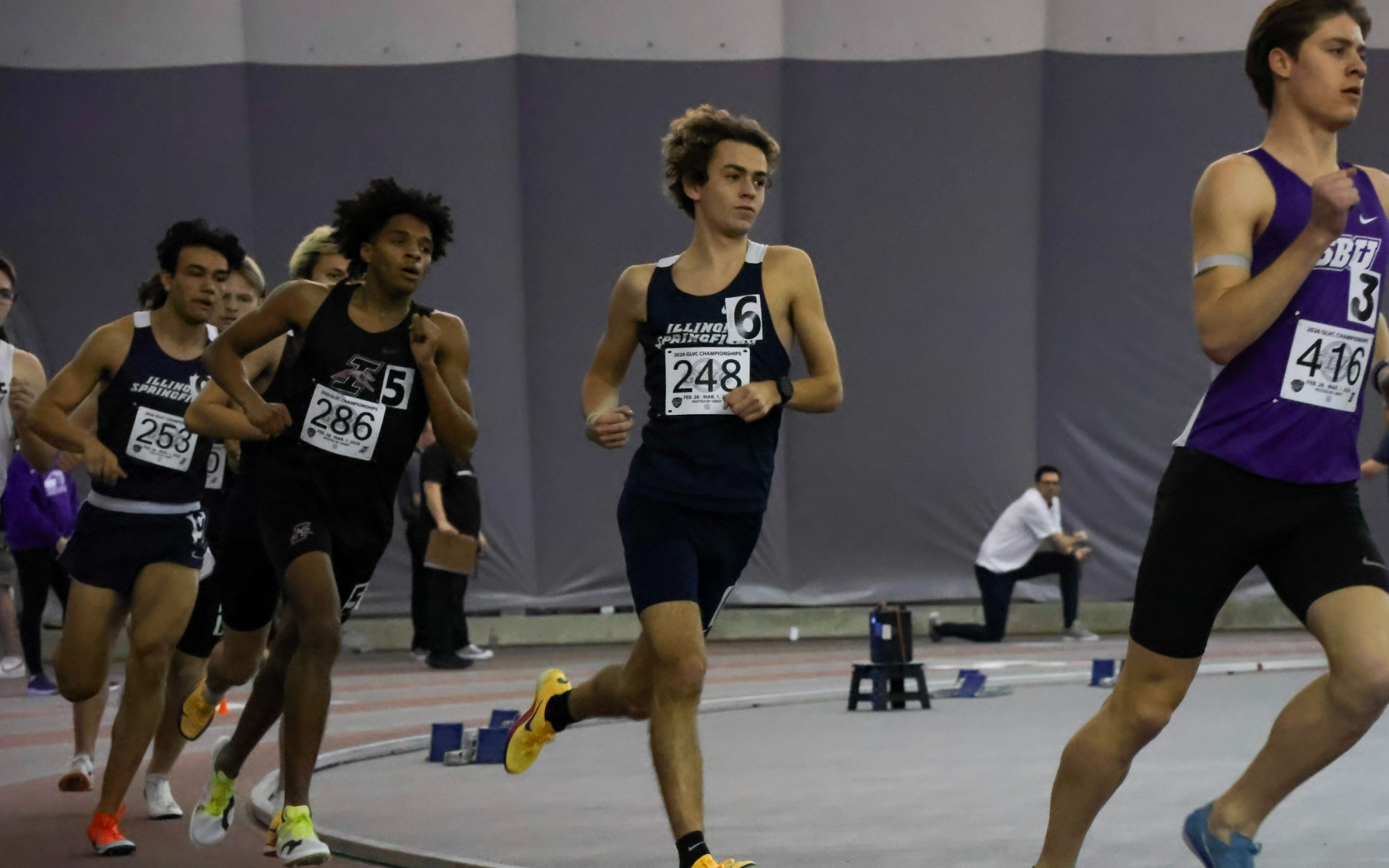 Charlie Borlin running indoor track at GLVC Championships