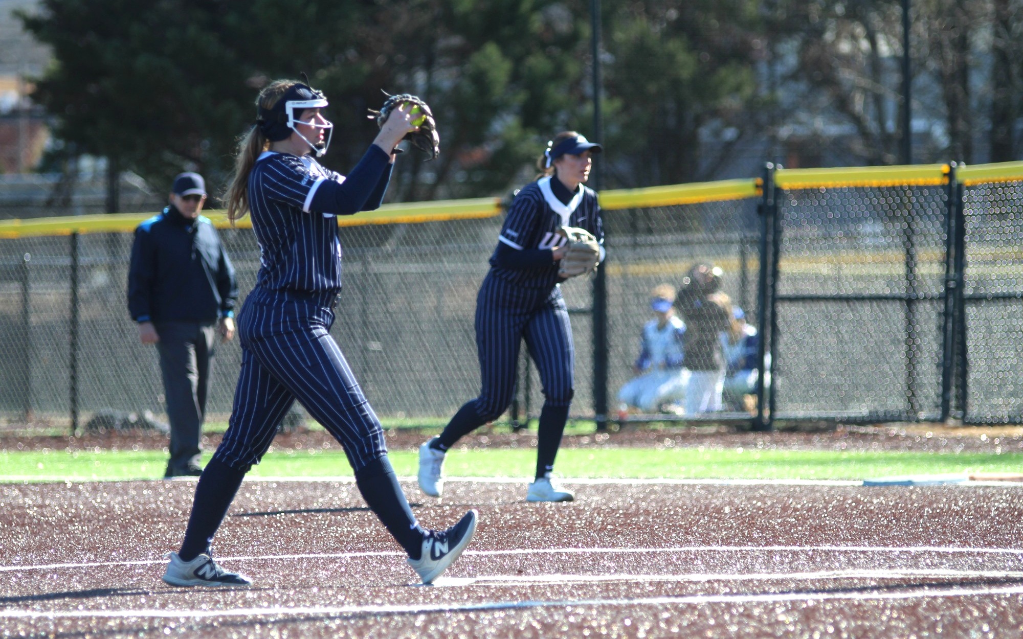 Alexis Carroll pitching in blue UIS uniform