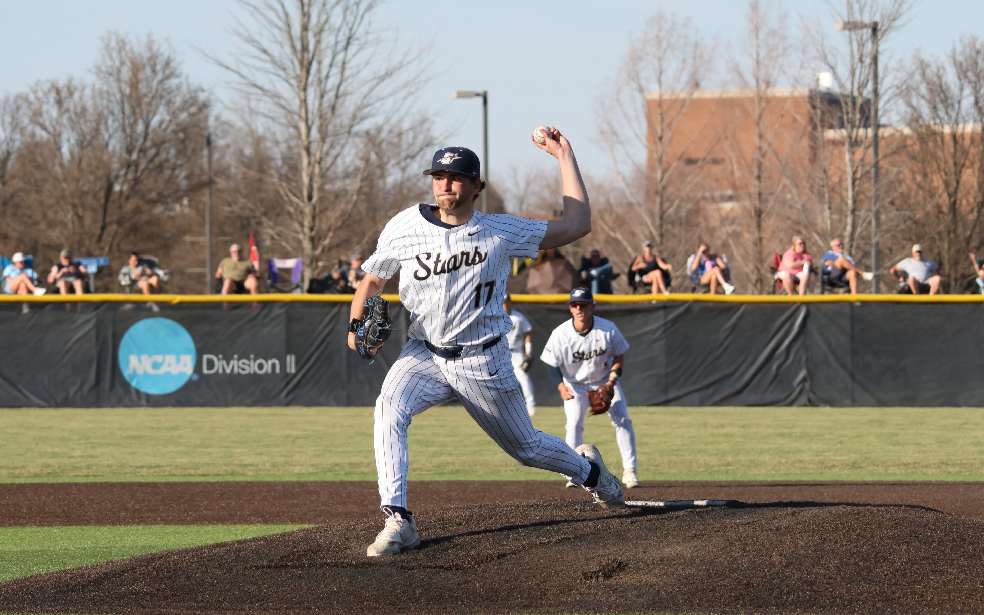 Graham Kasey pitching in white UIS uniform