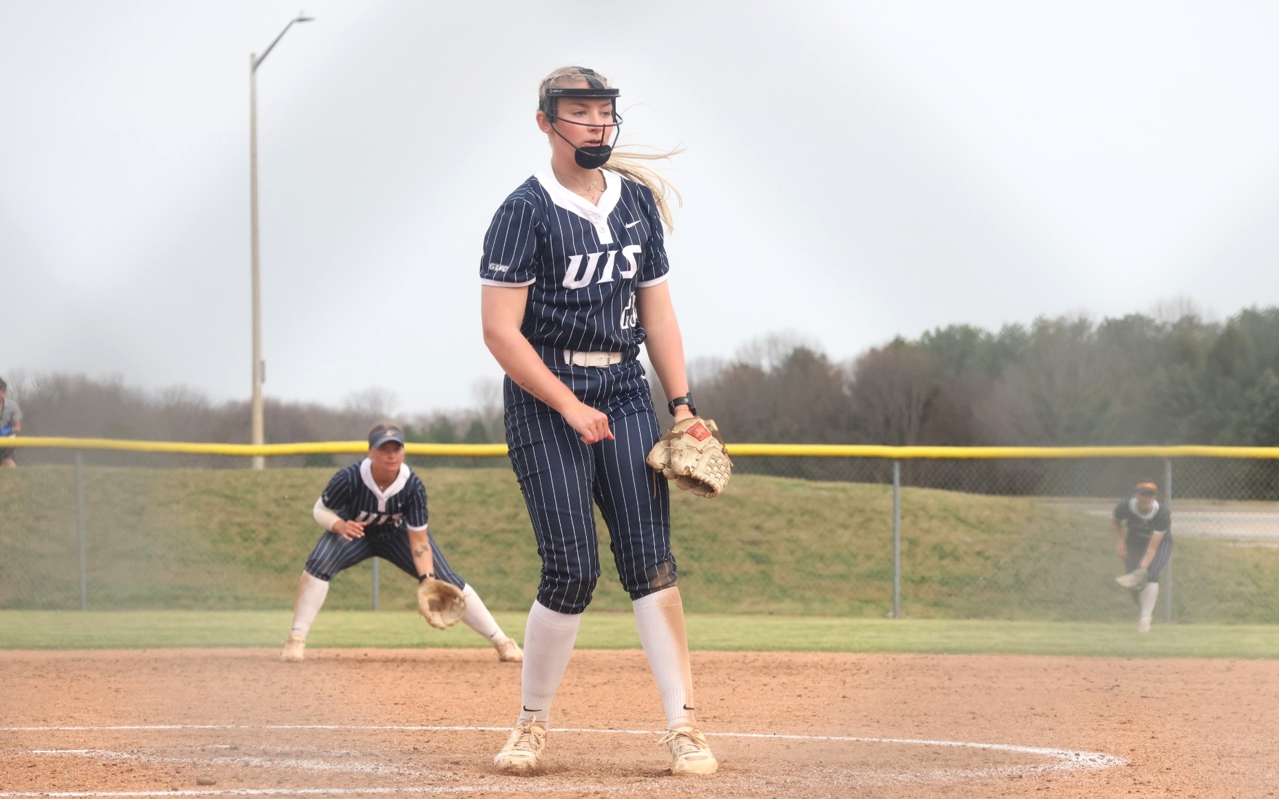 Calista Stahlhut  pitching in blue UIS uniform
