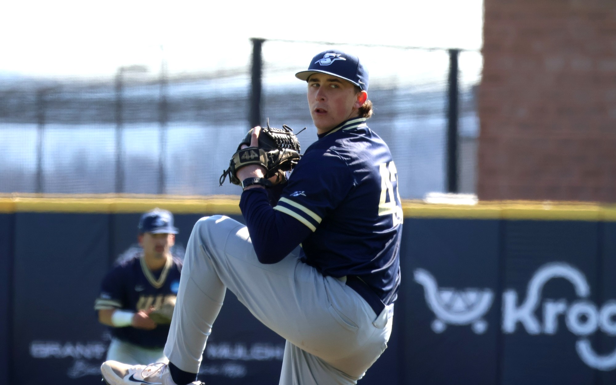 Jacob McPherson pitching in blue UIS baseball uniform