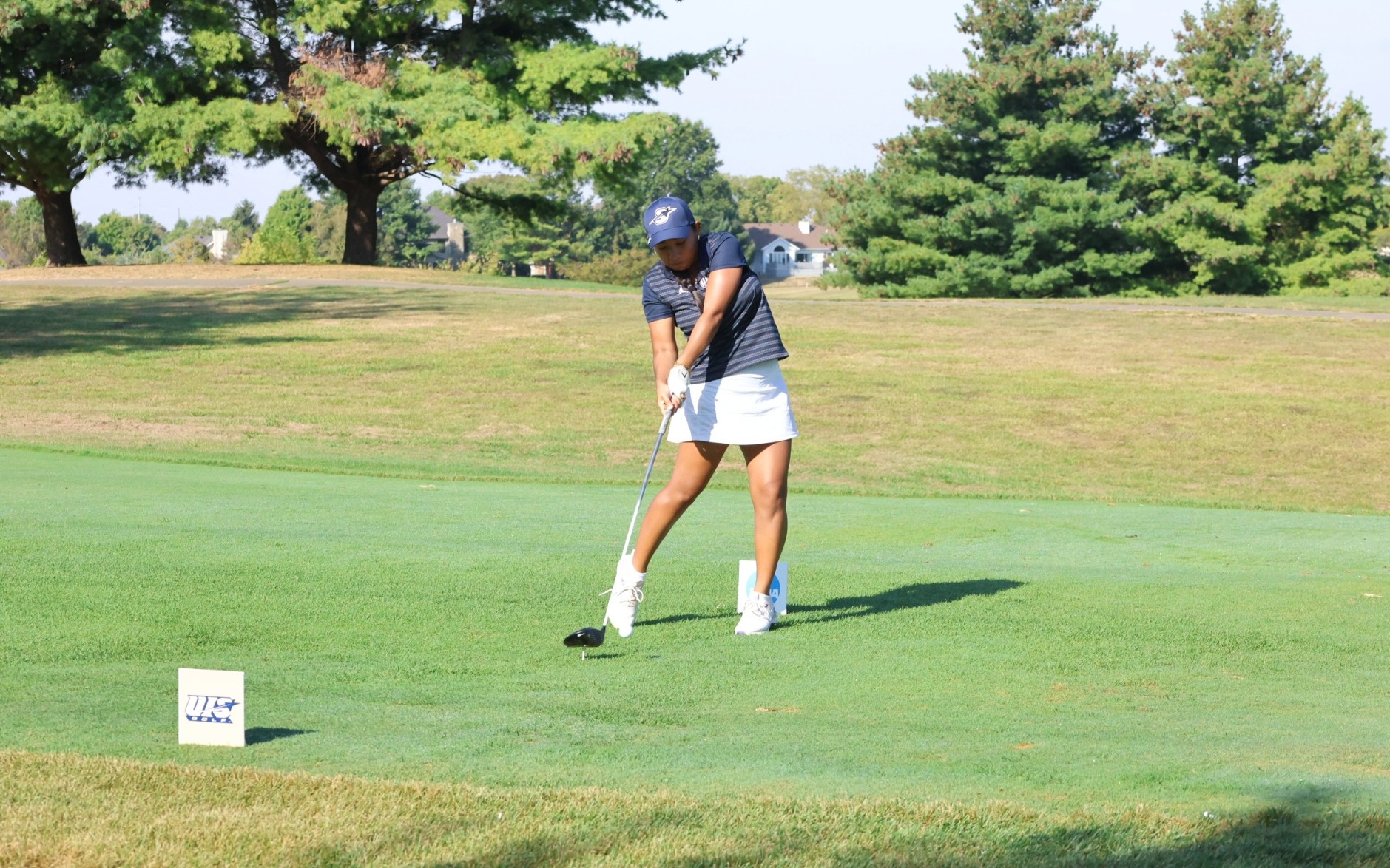 Erin Ahmadfadzir golfing in blue and white UIS golf gear