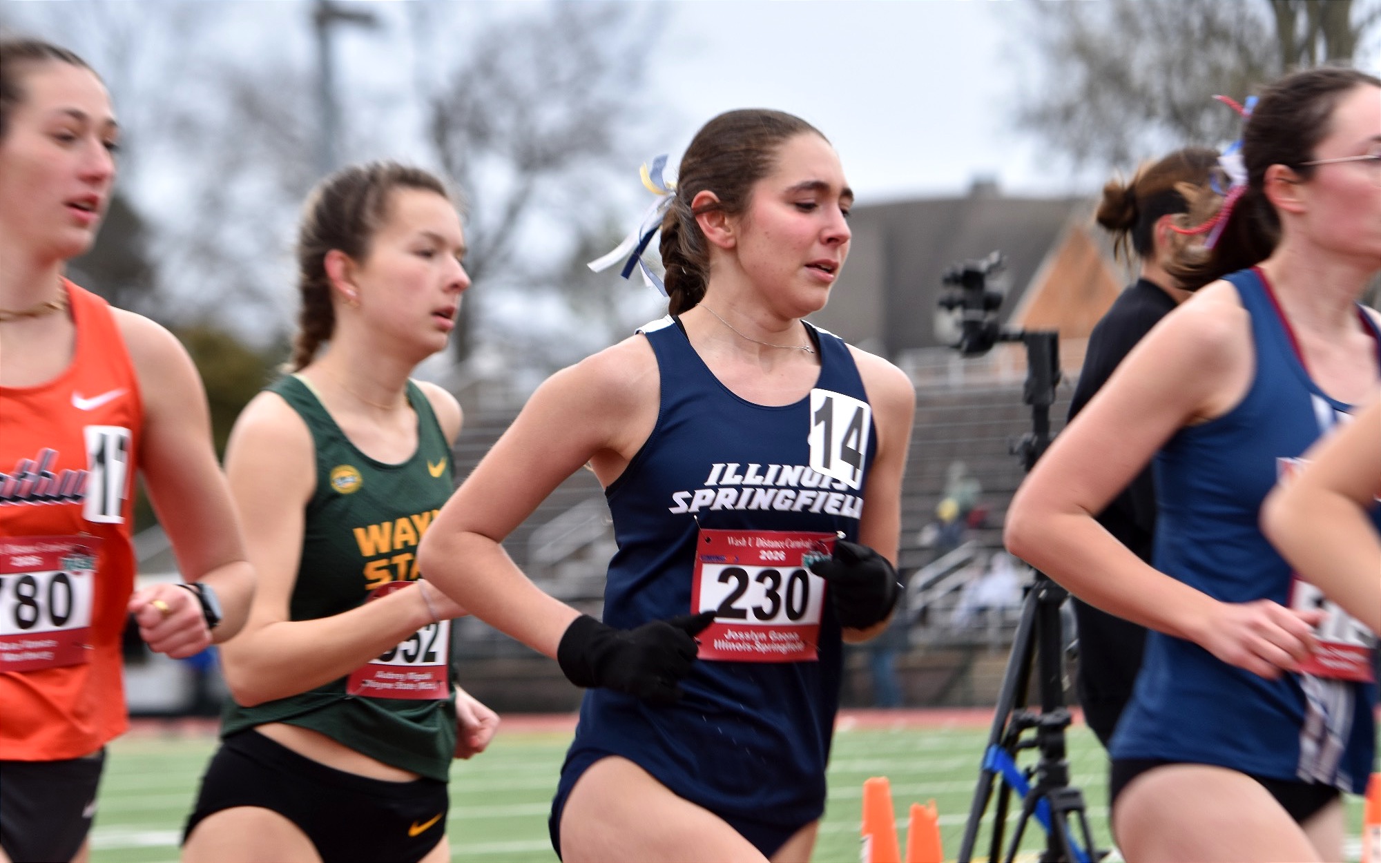 Josslyn Gaona running outdoor track in blue uis uniform