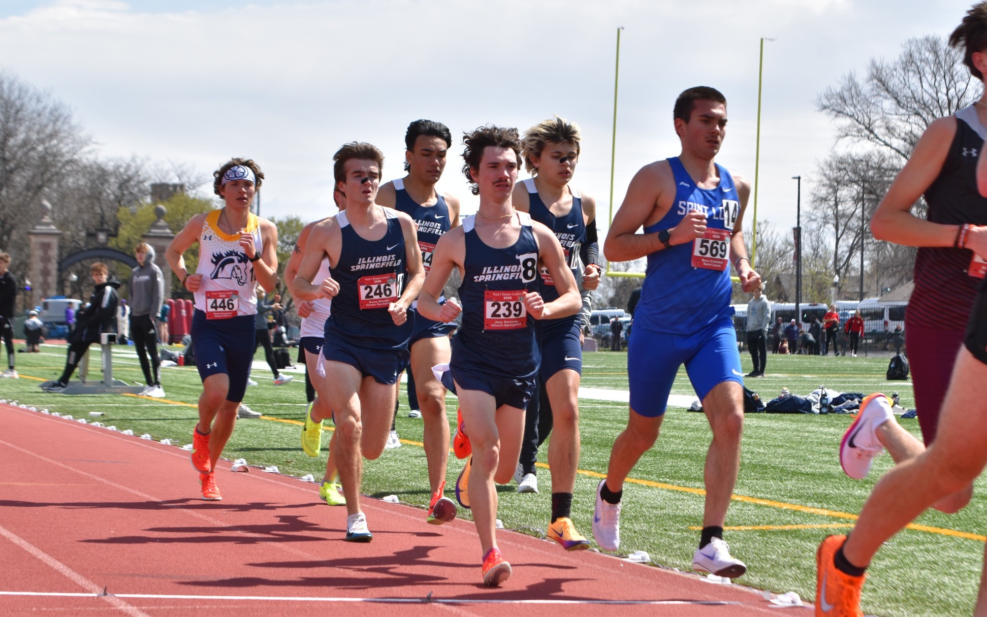 UIS Men's Track runners in blue uniforms running on track
