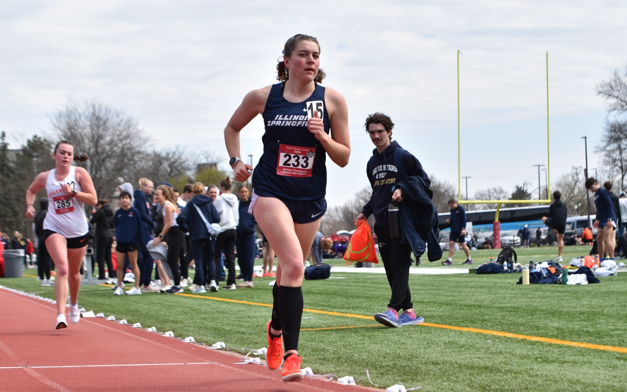 Allison Thompson running track in blue UIS uniform