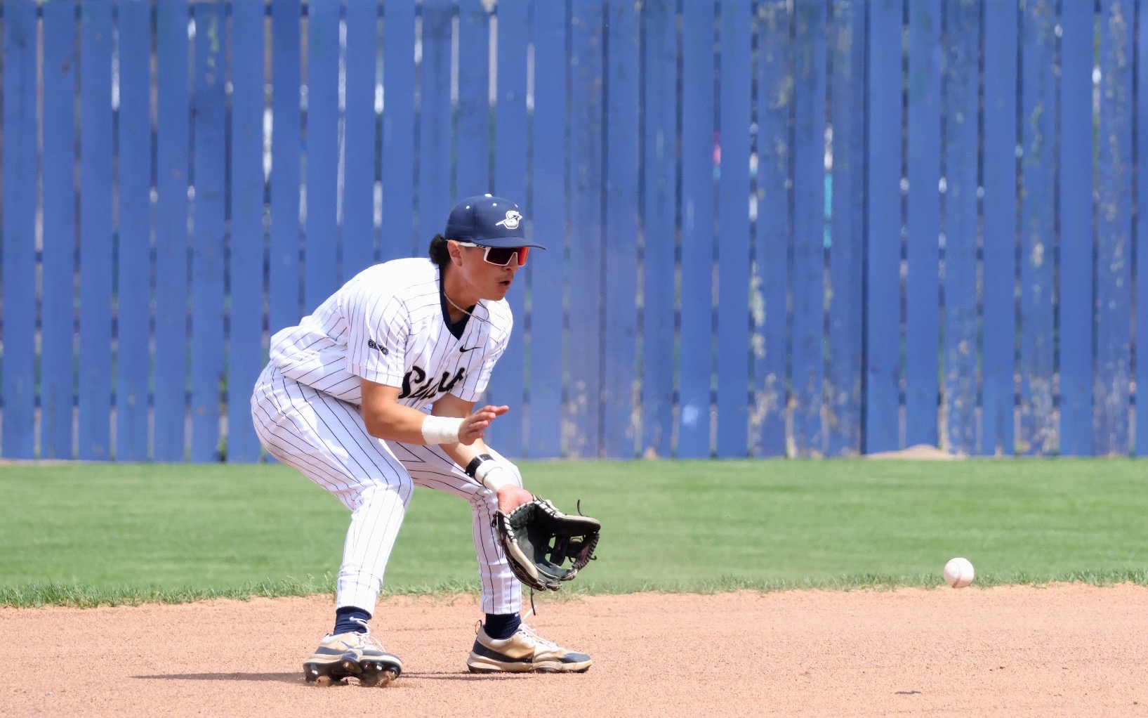 Jesse Contreras playing shortstop in white UIS baseball uniform