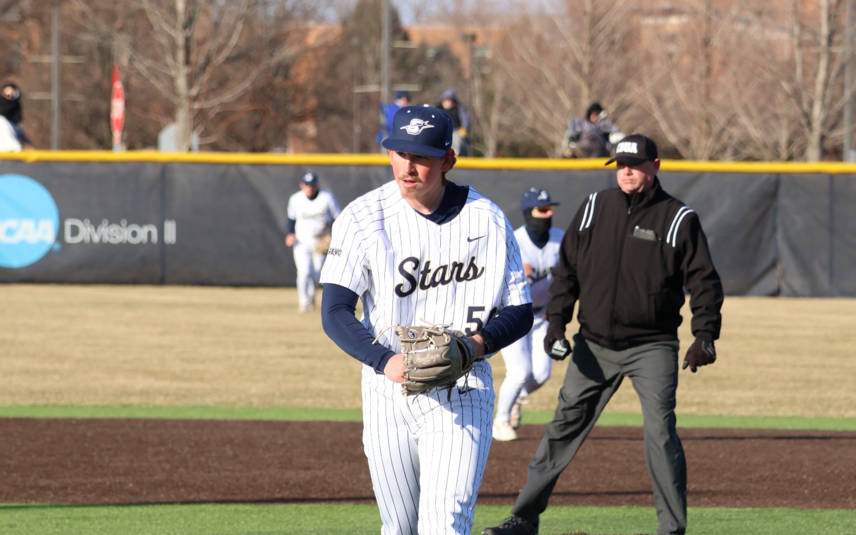 Austin Loberger pitching in white UIS uniform
