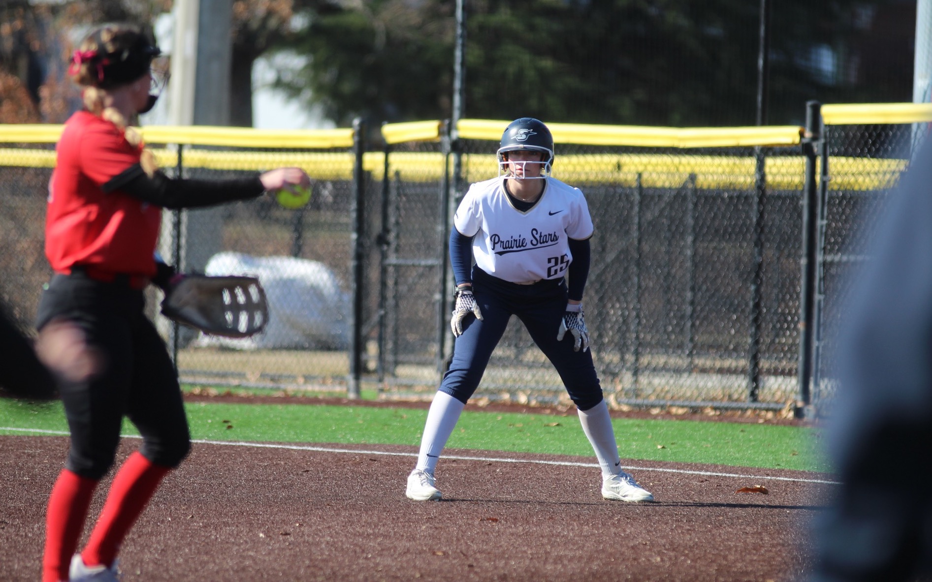 Calista Stahlhut on first base in white UIS uniform