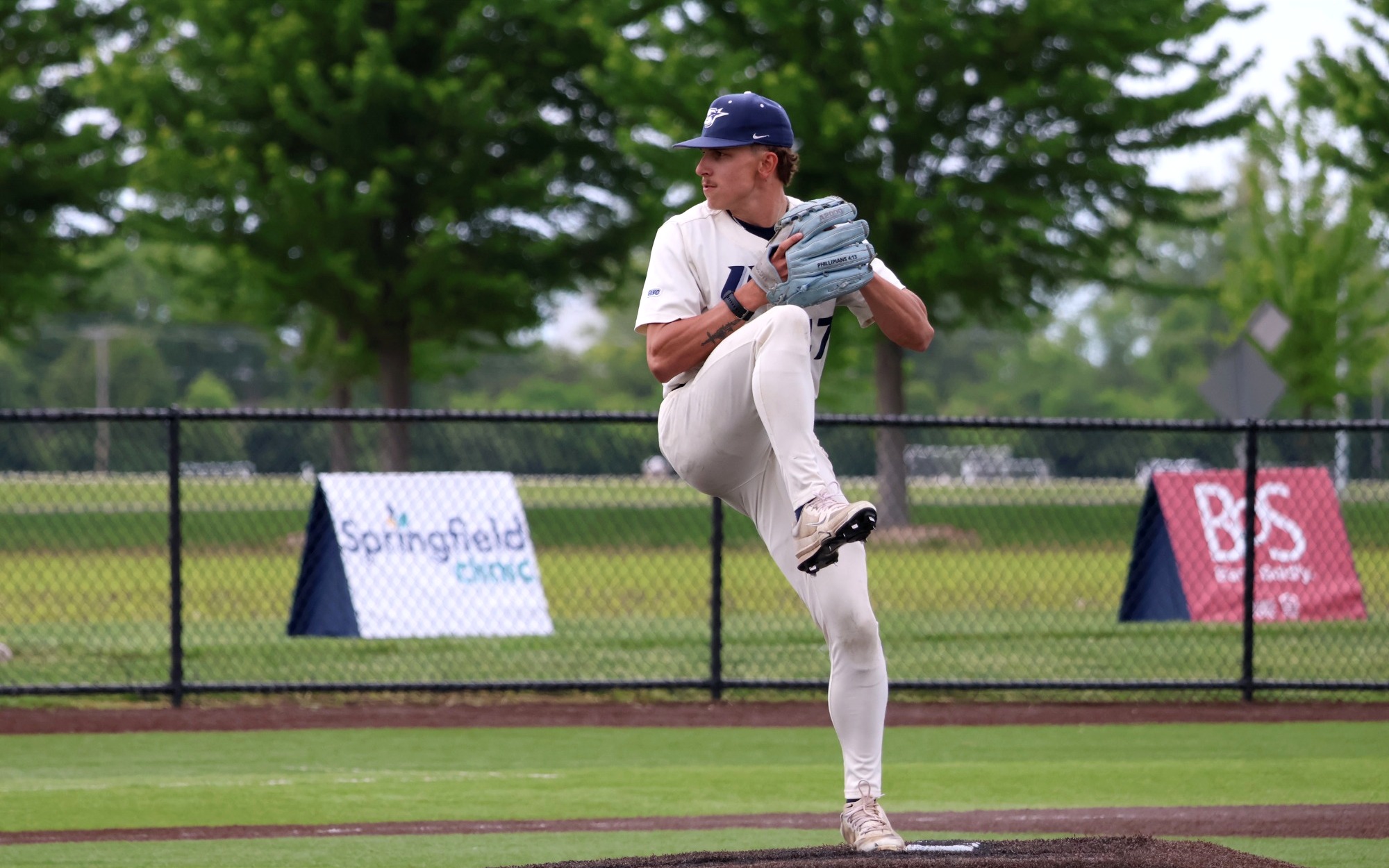 Jaden Mathon pitching for UIS in white uniform