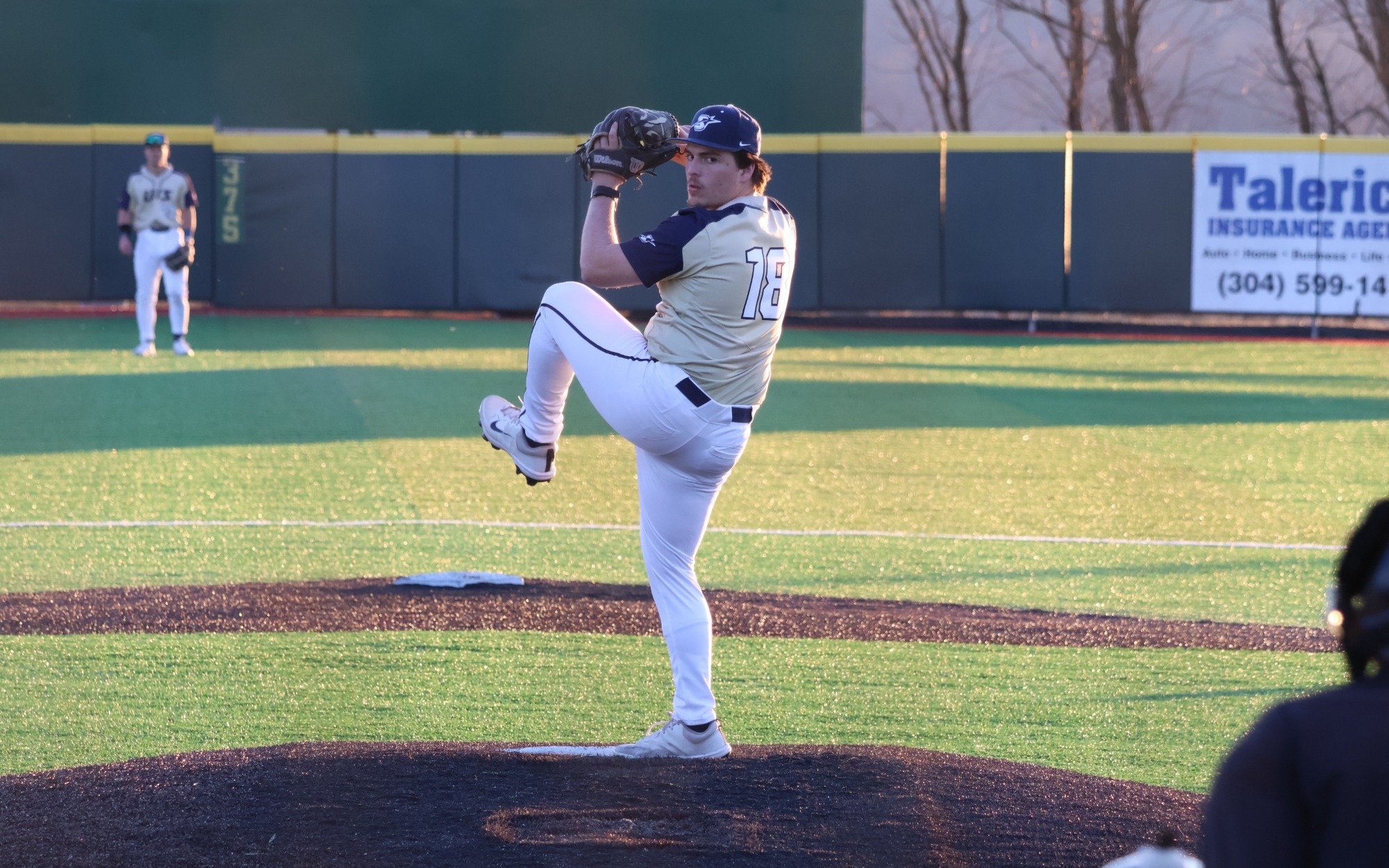 Isaac Graf  pitching in gold UIS uniform