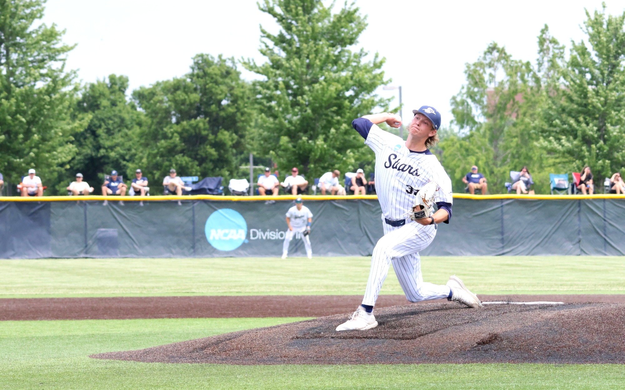 Mark DeCicco pitching at UIS Baseball Field in white uniform