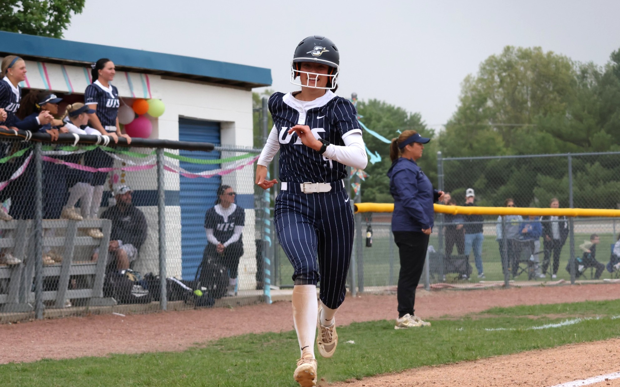 Jaden Watts running home in a softball game
