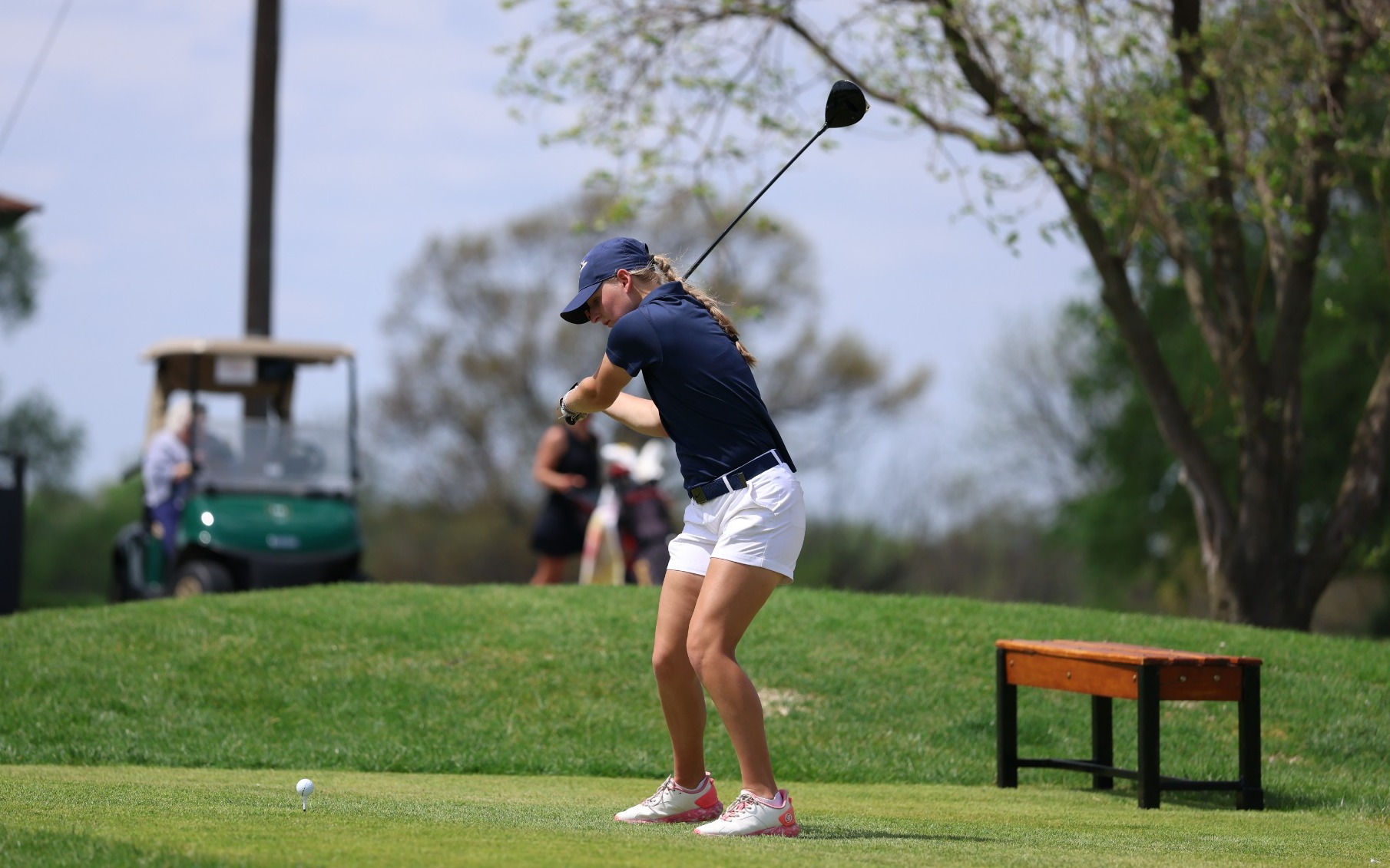 Elaine Grant golfing in blue UIS polo and hat