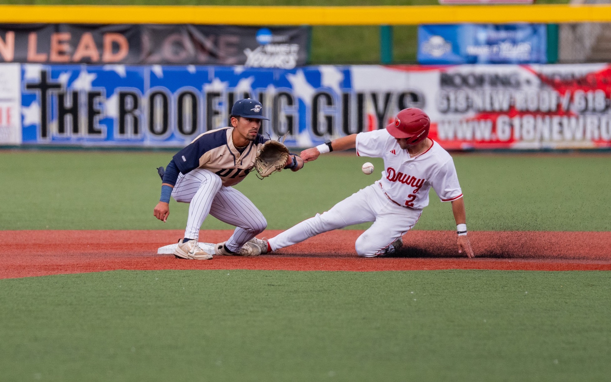 Noah Caceres playing second base in gold baseball uniform